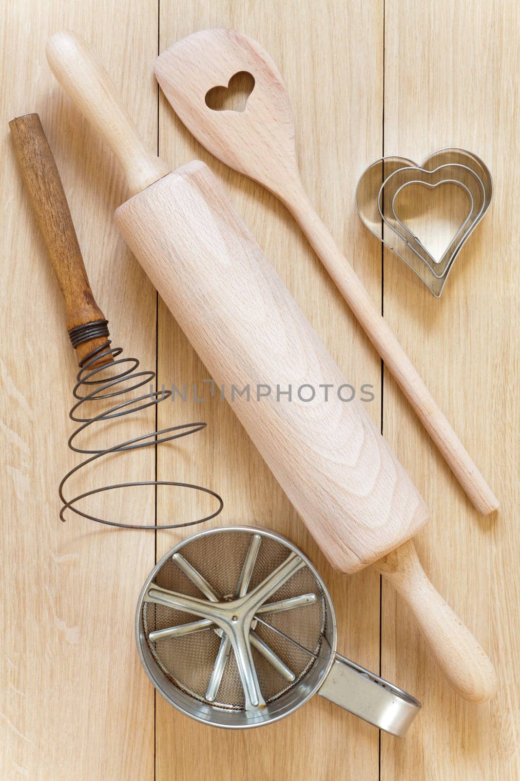 Various baking utensils made of wood and metal