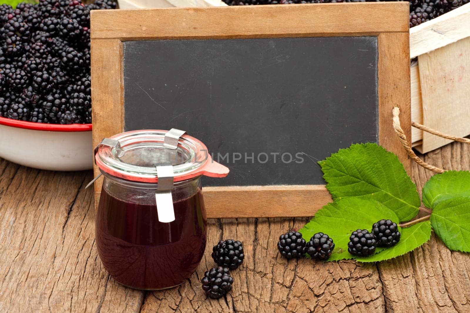 Homemade blackberry jelly and empty slate