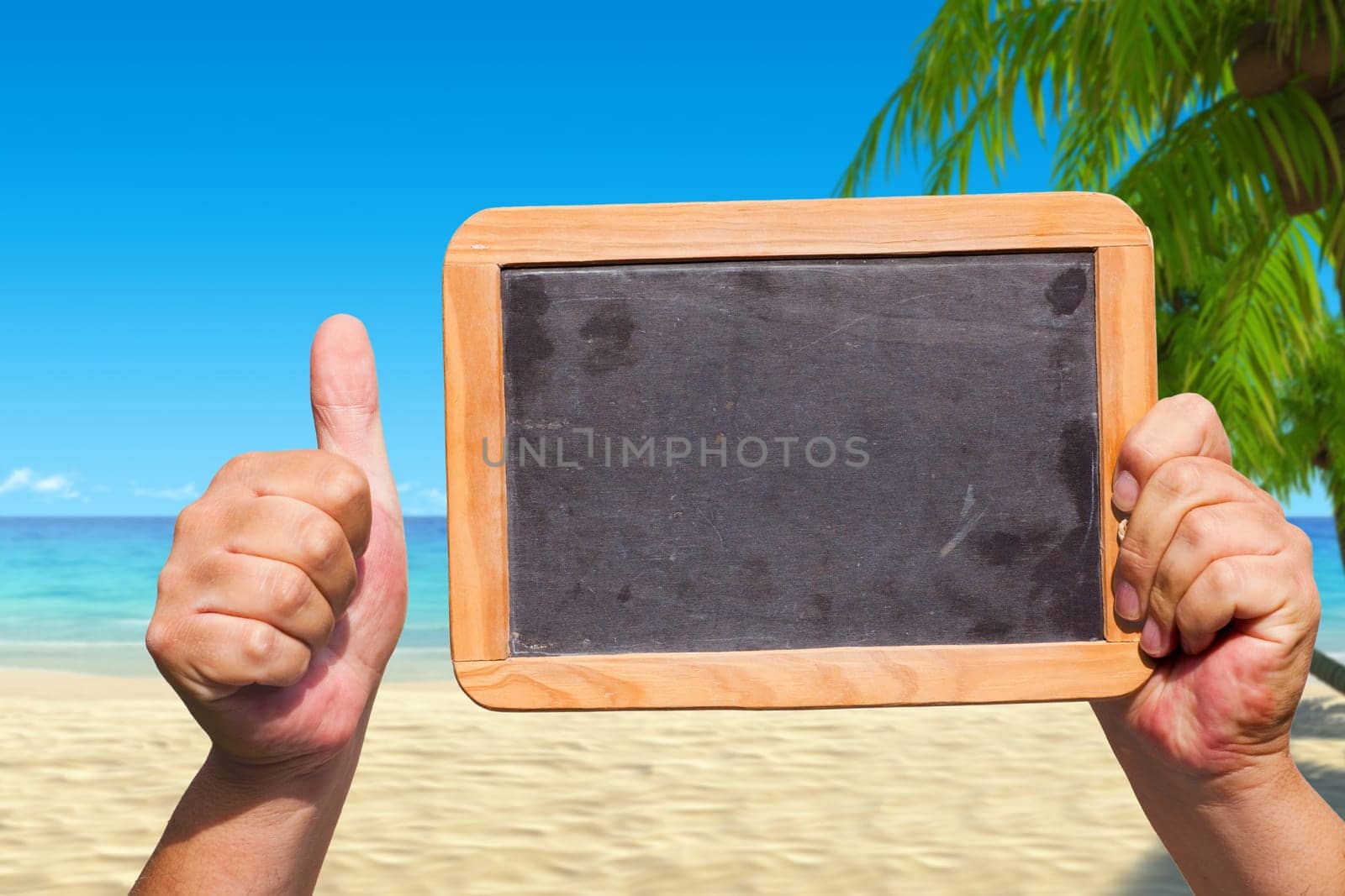 Thumbs up,hands holding empty table on the beach