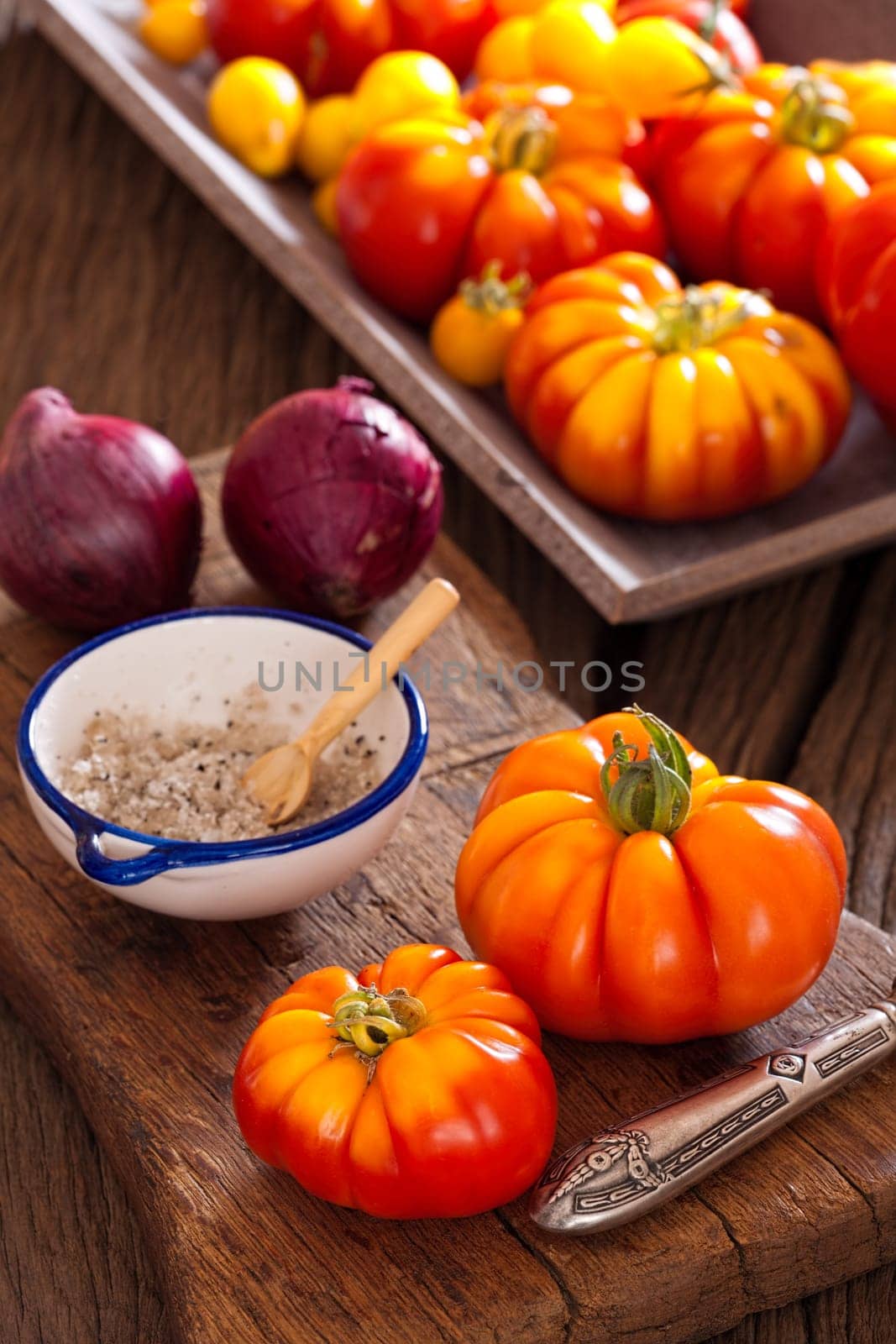Freshly harvested tomatoes with onions and salt