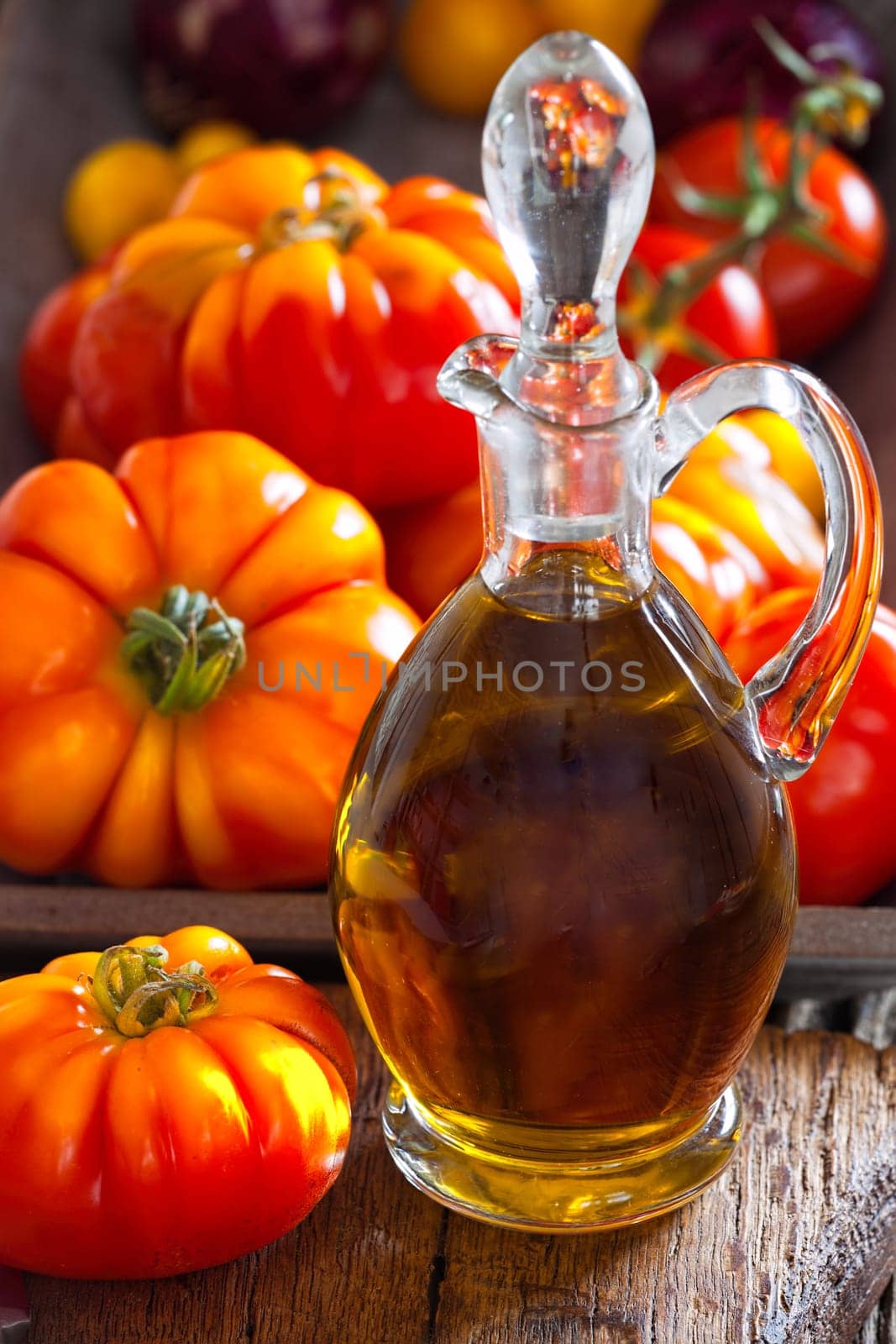 Carafe olive oil and freshly harvested meat tomatoes