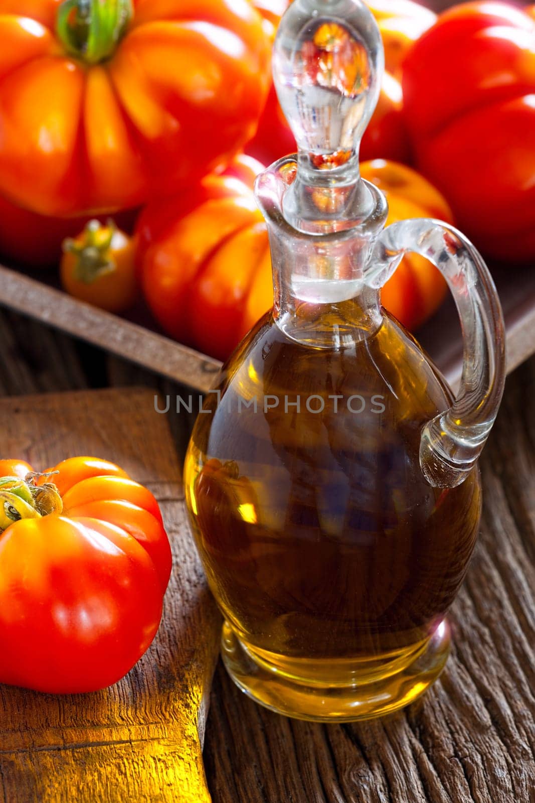 Fresh meat tomatoes and carafe with olive oil