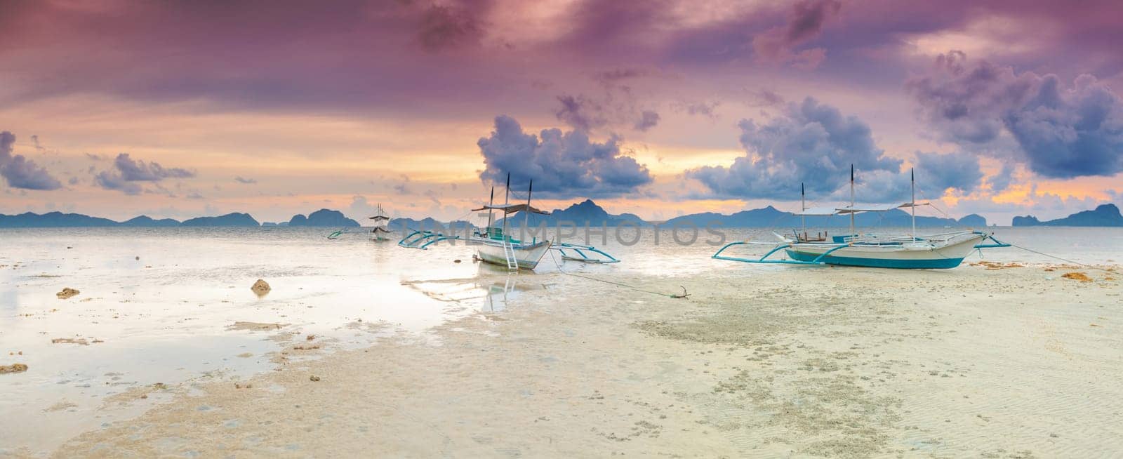 Traditional philippine boats bangka at sunset time. Panorama