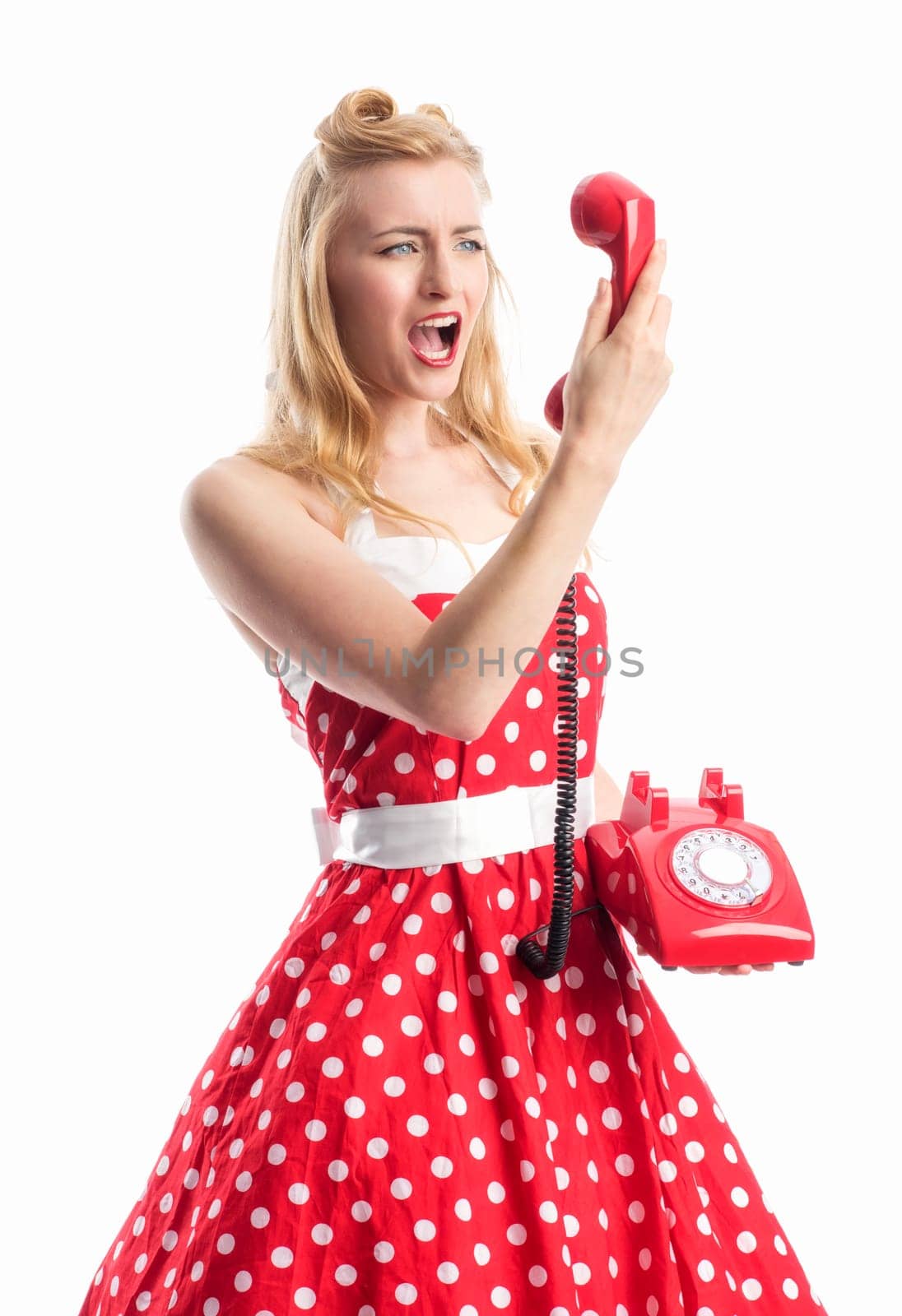 a woman in a rockabilly dress roars into a red phone handset