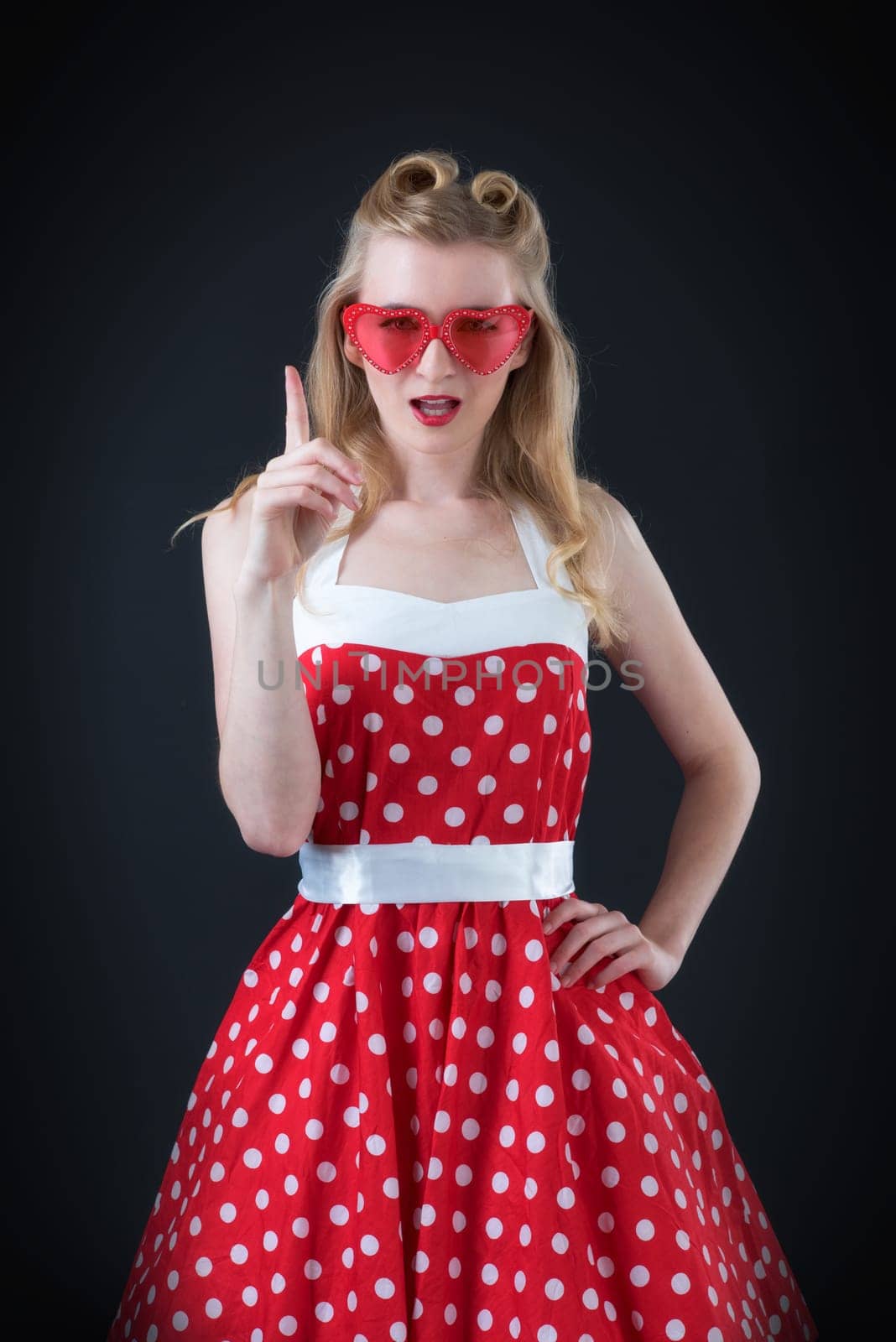 an arrogant woman in rockabilly style shows with her finger