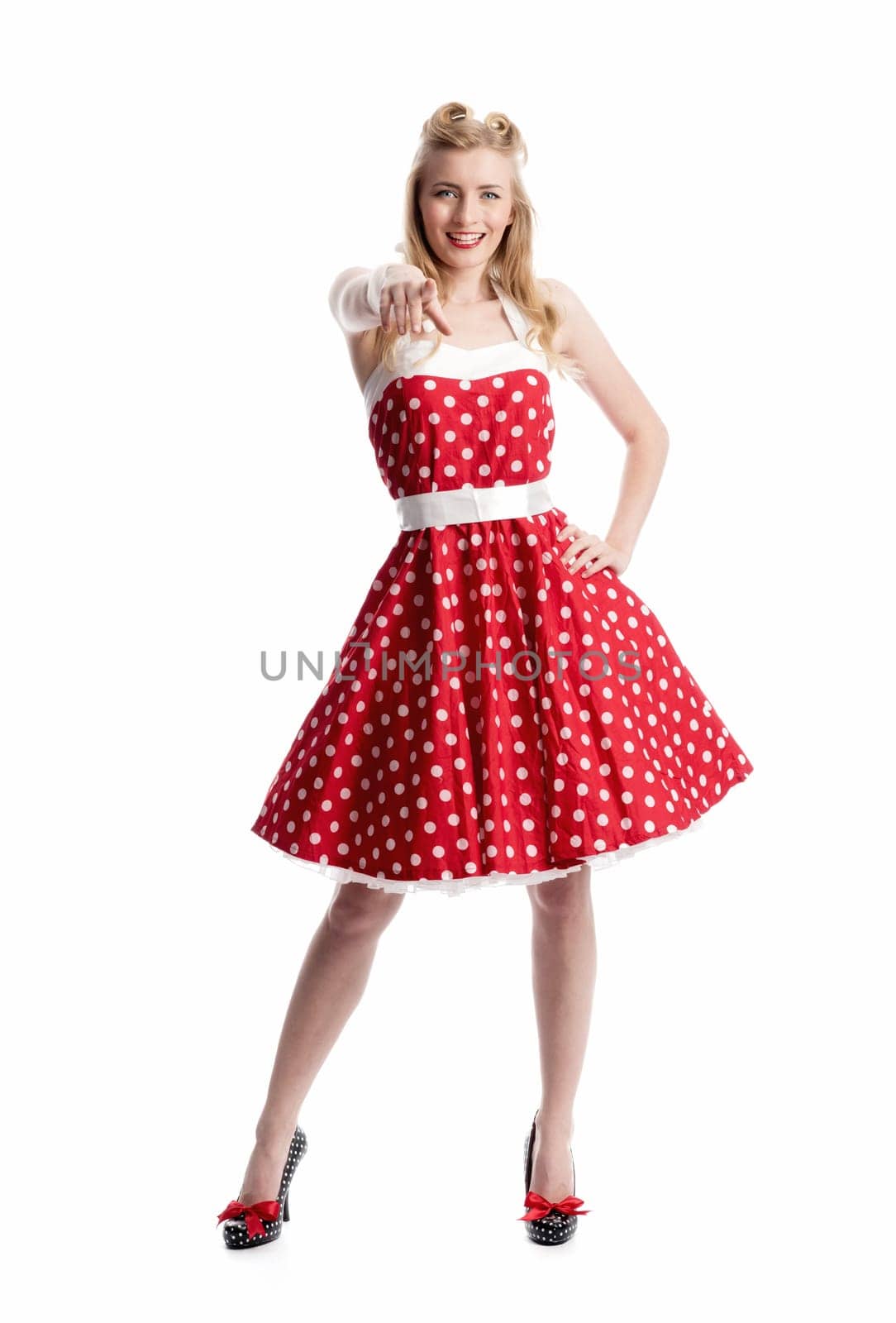 a woman in dotted dress gesticulated with her hands
