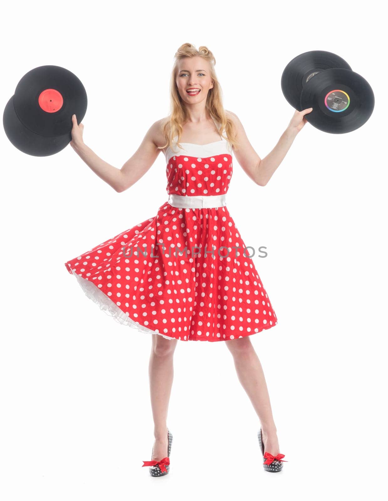 a woman in rockabilly style holds records as advertising space