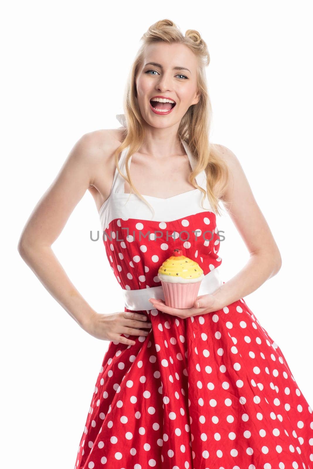 a young woman in a summer dress holding a cupcake