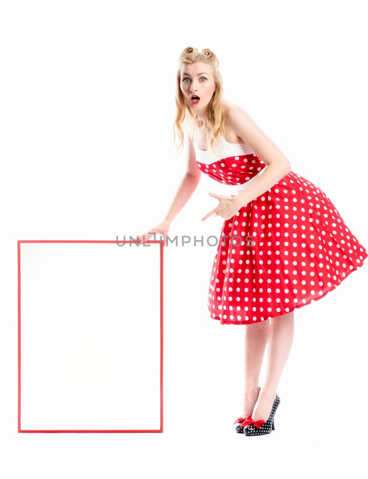 a pin up girl in summer dress holds an advertising poster