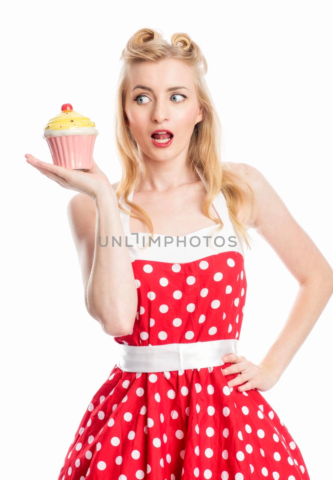 a woman in summer dress holds a delicious cupcake in her hand