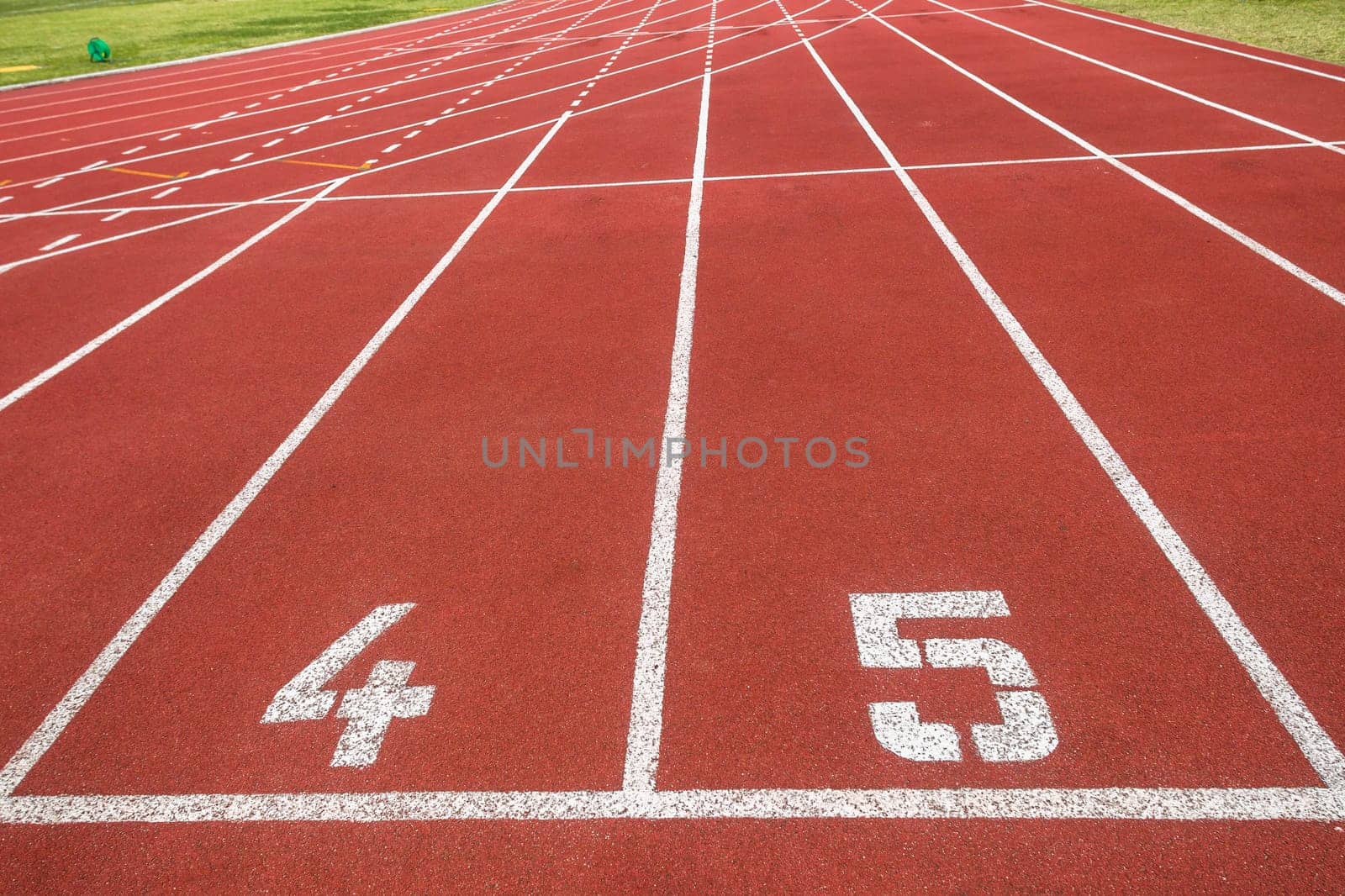 Athletic one hundred meter starting line at lanes four and five for sprinters.