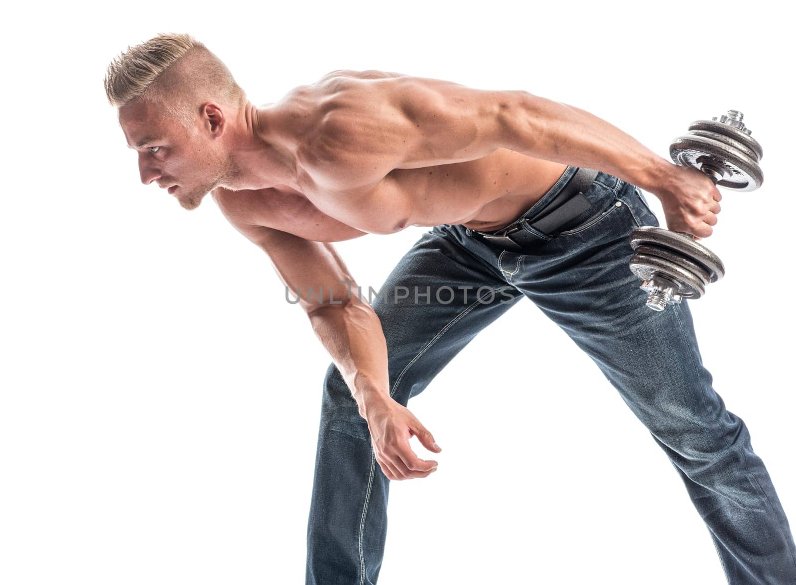 a man with a well-trained body exercises with a dumbbell