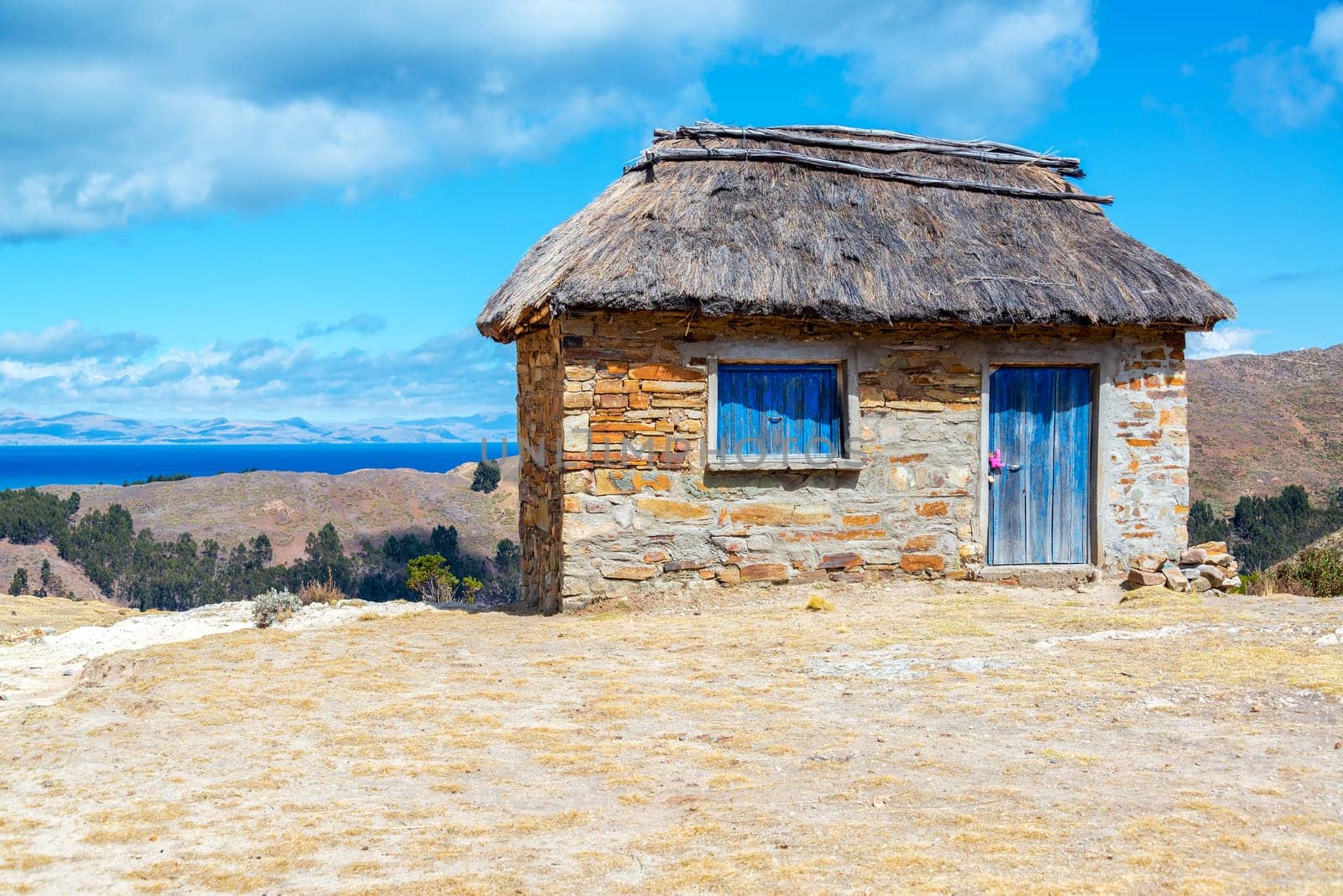 Stone building with thatch roof on Isla del Sol on the Bolivian side of Lake Titicaca