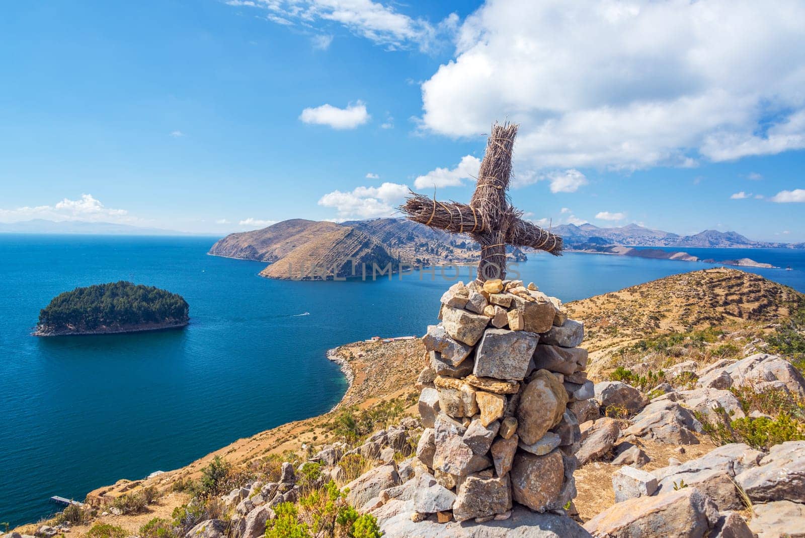 Cross on a hill with Lake Titicaca in the background taken from Isla del Sol in Bolivia