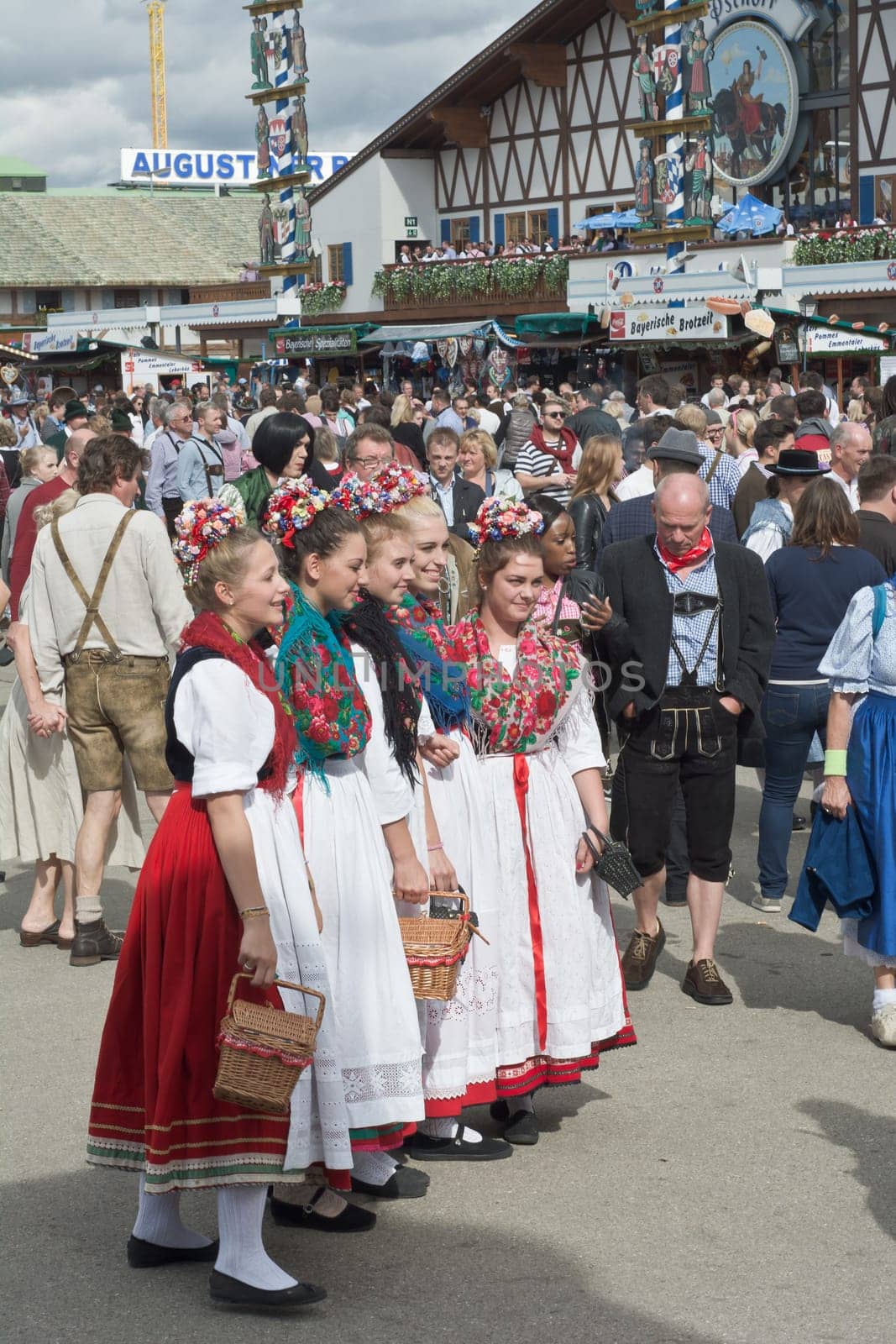 MUNICH, GERMANY – SEPT. 21, 2014: Crowds of visitors at the 181st Oktoberfest celebrating the festivities with Traditional Dress. The Festival runs from Sept. 20 – Oct. 5  in Munich, Germany