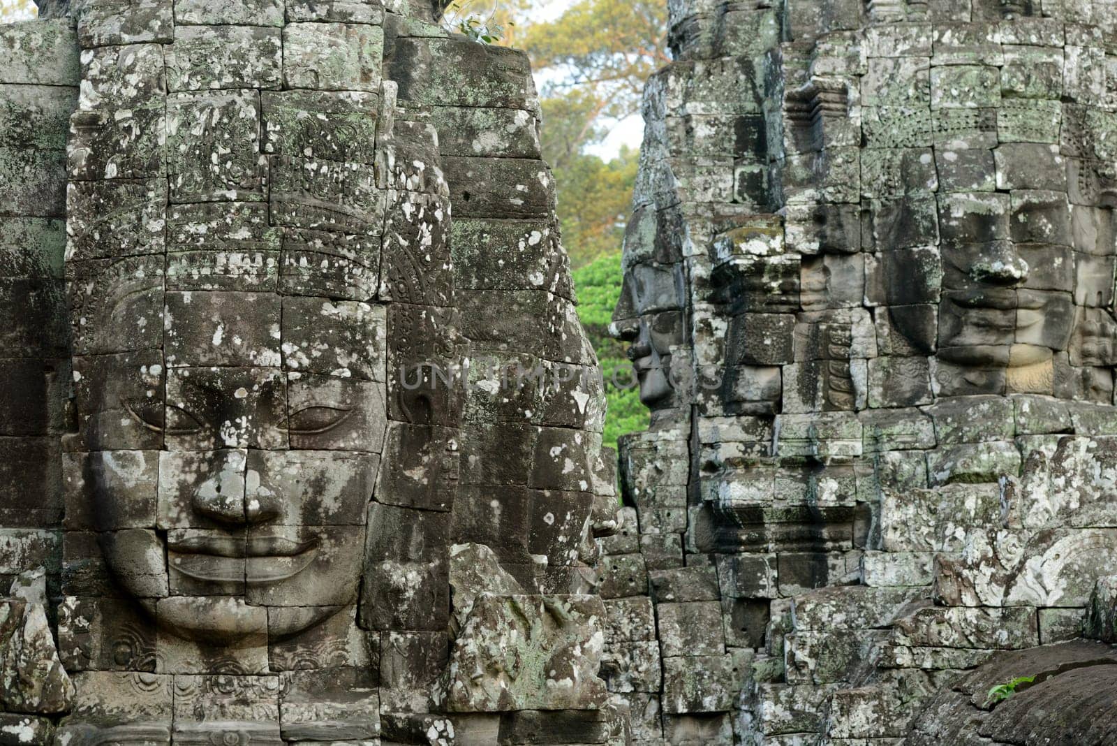 Stone Faces the Tempel Ruin of Angkor Thom in the Temple City of Angkor near the City of Siem Riep in the west of Cambodia.