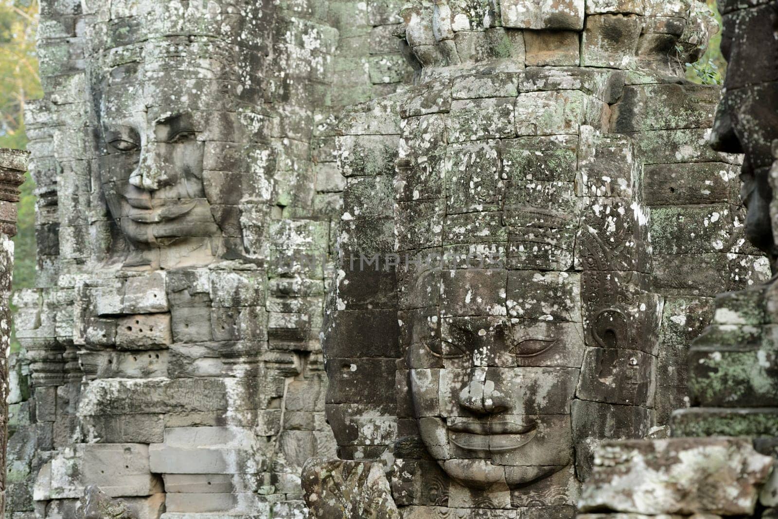 Stone Faces the Tempel Ruin of Angkor Thom in the Temple City of Angkor near the City of Siem Riep in the west of Cambodia.