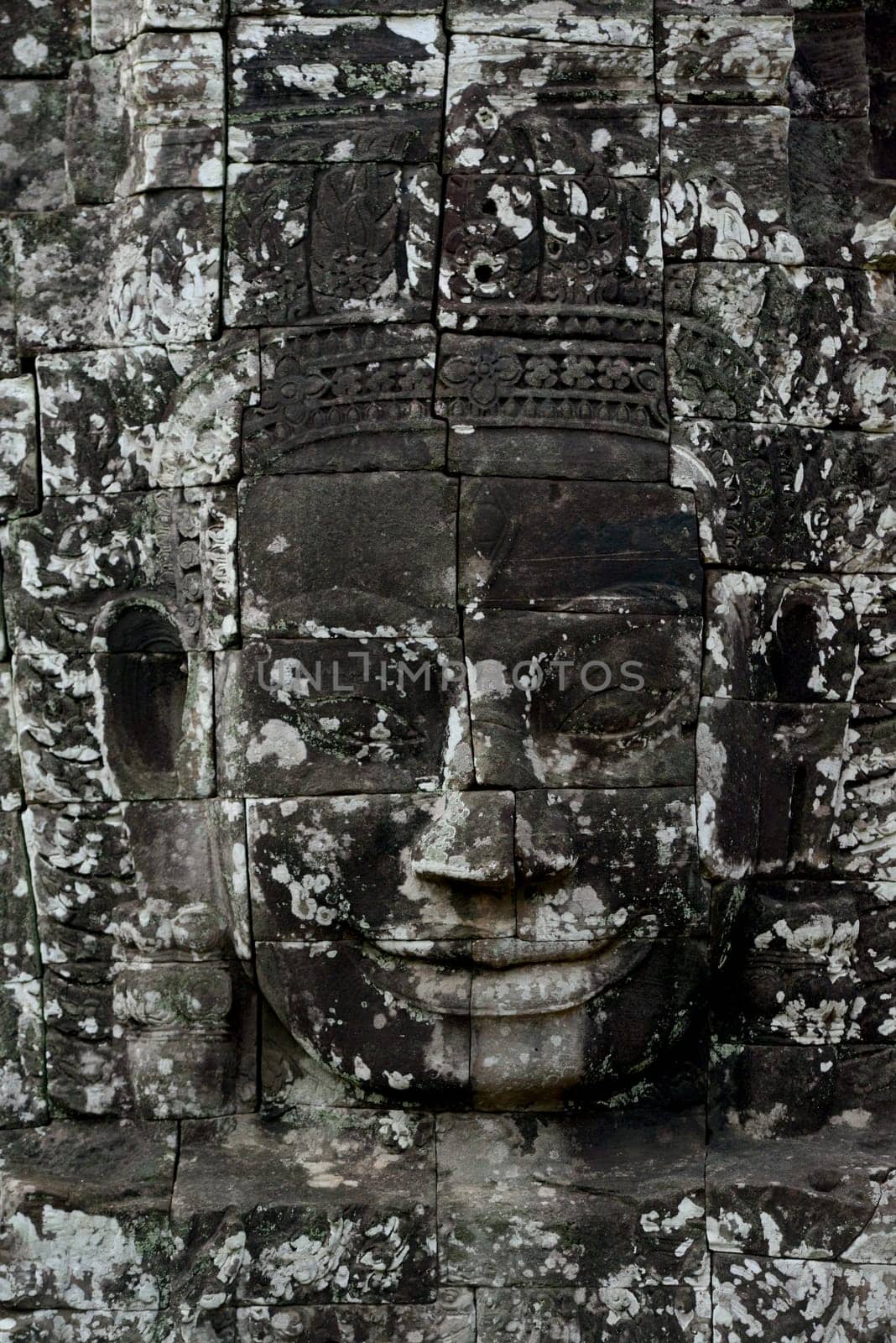 Stone Faces the Tempel Ruin of Angkor Thom in the Temple City of Angkor near the City of Siem Riep in the west of Cambodia.