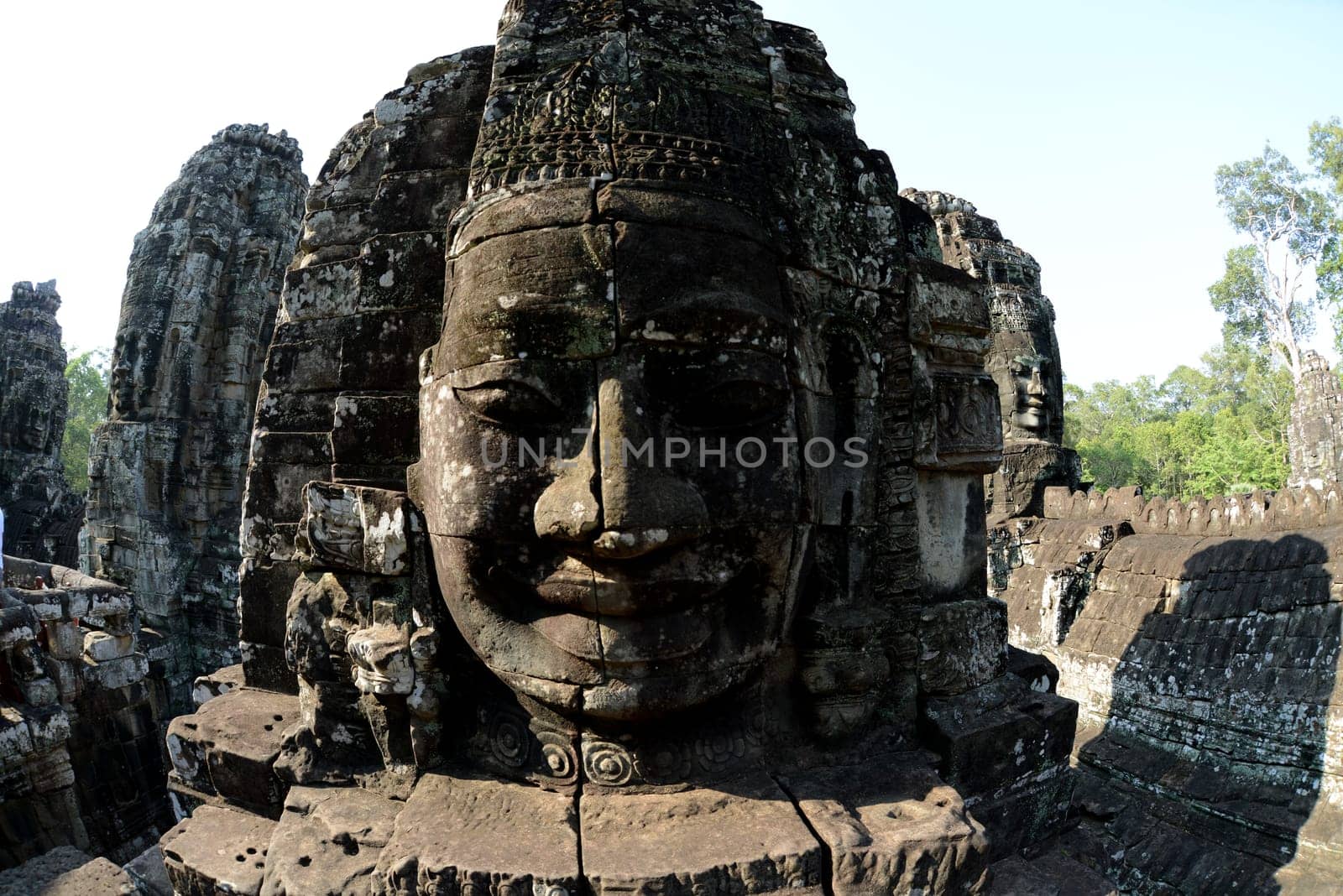 Stone Faces the Tempel Ruin of Angkor Thom in the Temple City of Angkor near the City of Siem Riep in the west of Cambodia.