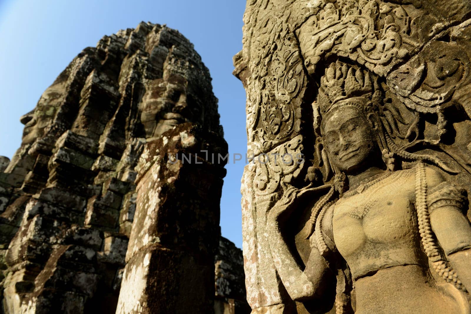 Stone Faces the Tempel Ruin of Angkor Thom in the Temple City of Angkor near the City of Siem Riep in the west of Cambodia.