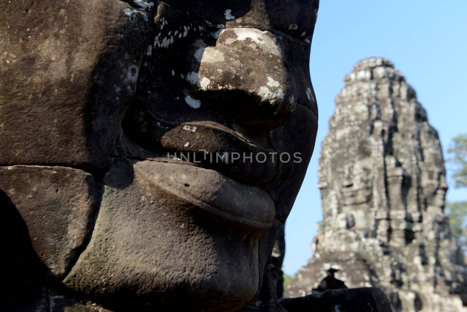Stone Faces the Tempel Ruin of Angkor Thom in the Temple City of Angkor near the City of Siem Riep in the west of Cambodia.