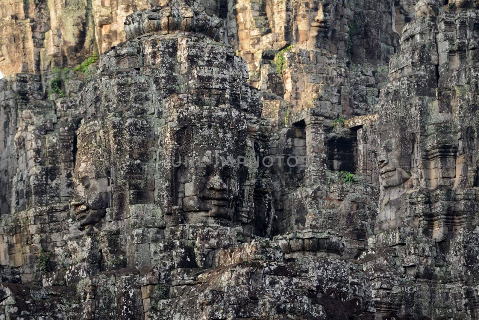 Stone Faces the Tempel Ruin of Angkor Thom in the Temple City of Angkor near the City of Siem Riep in the west of Cambodia.