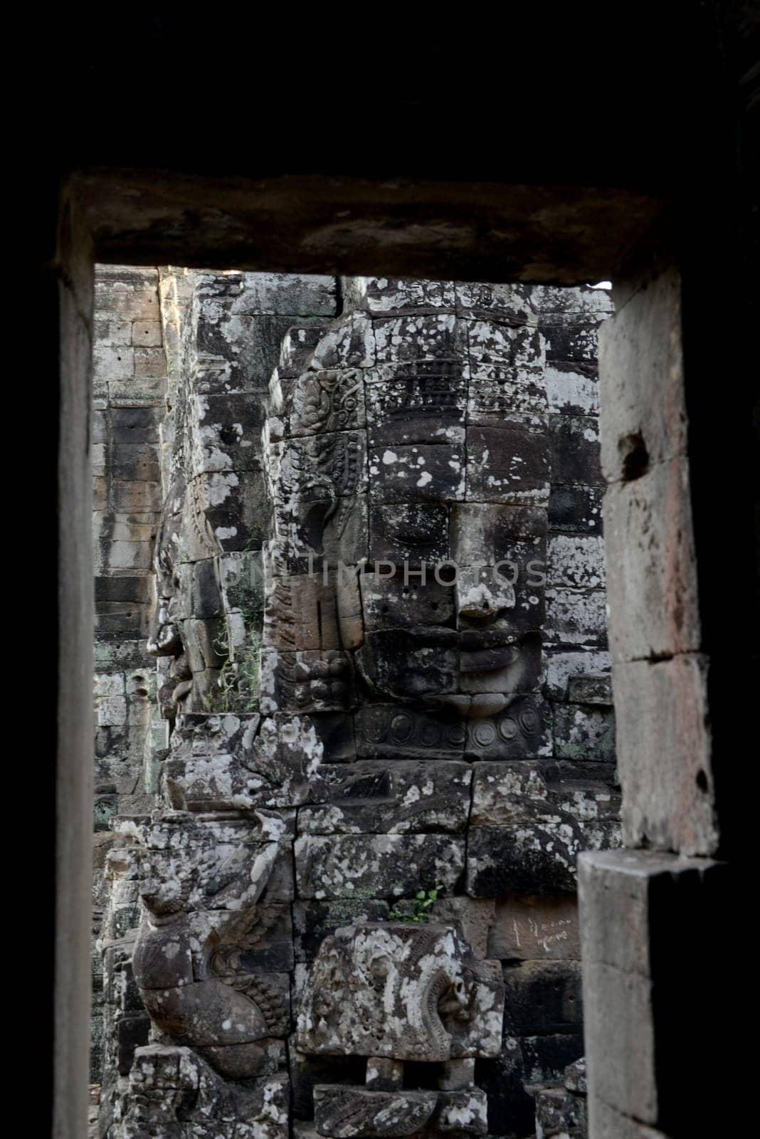 Stone Faces the Tempel Ruin of Angkor Thom in the Temple City of Angkor near the City of Siem Riep in the west of Cambodia.