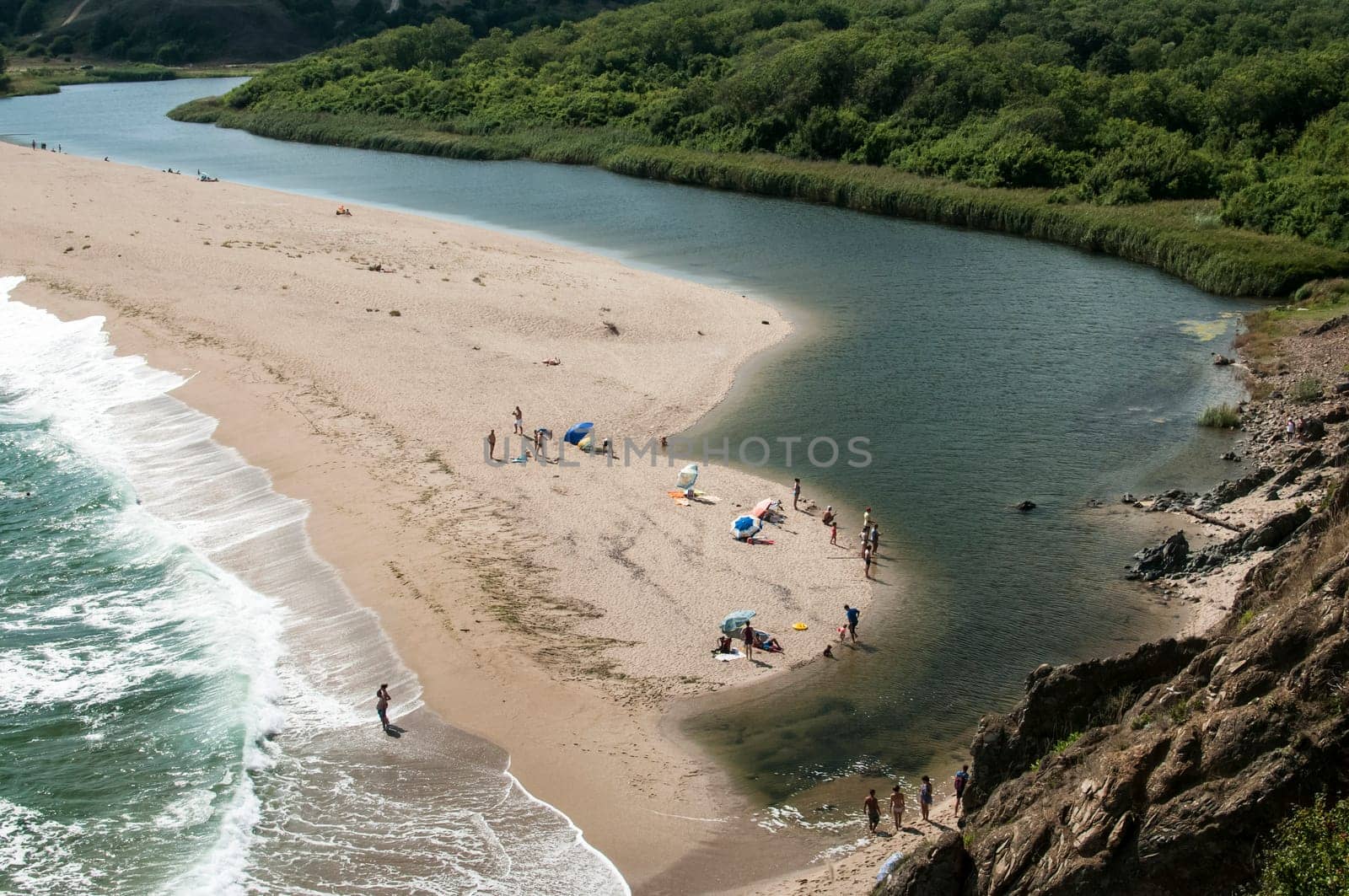 Mouth of the river flows into sea at sand beach landscape