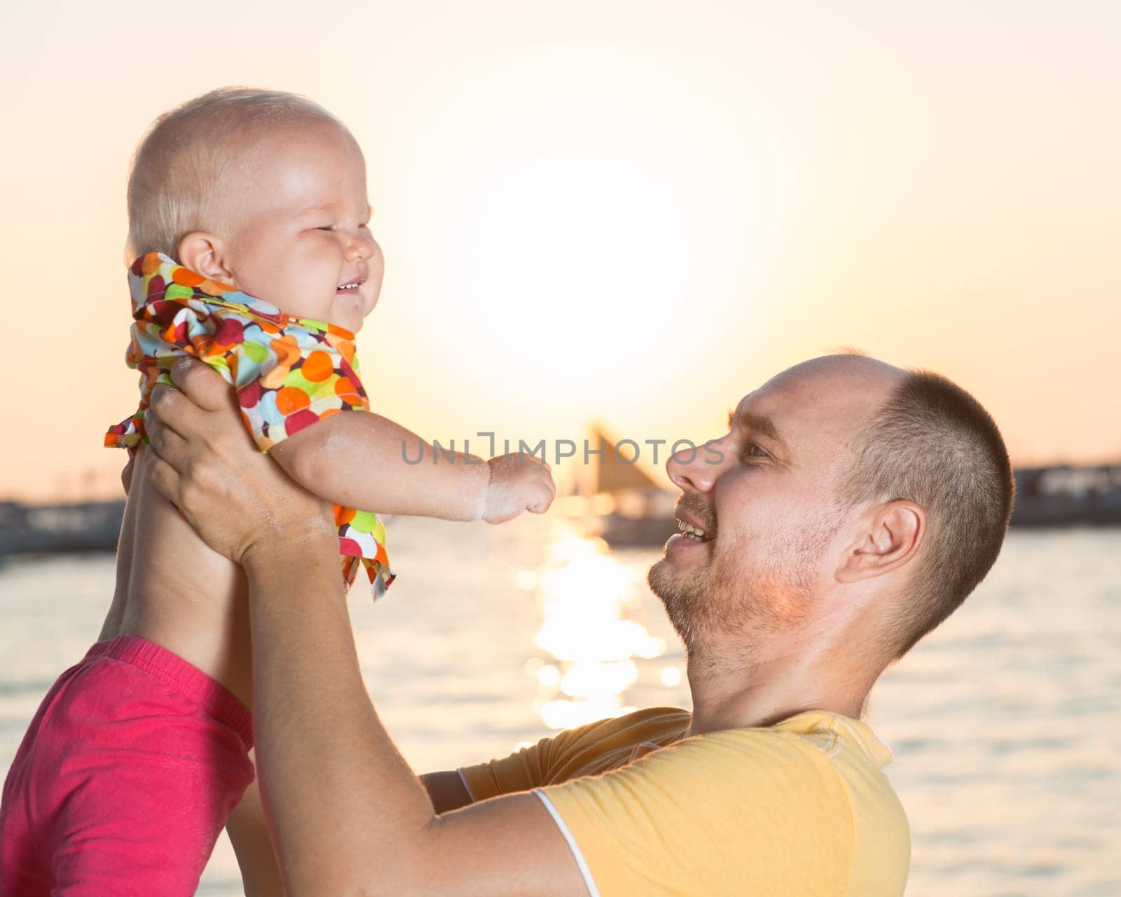 Baby and father on the tropical beach