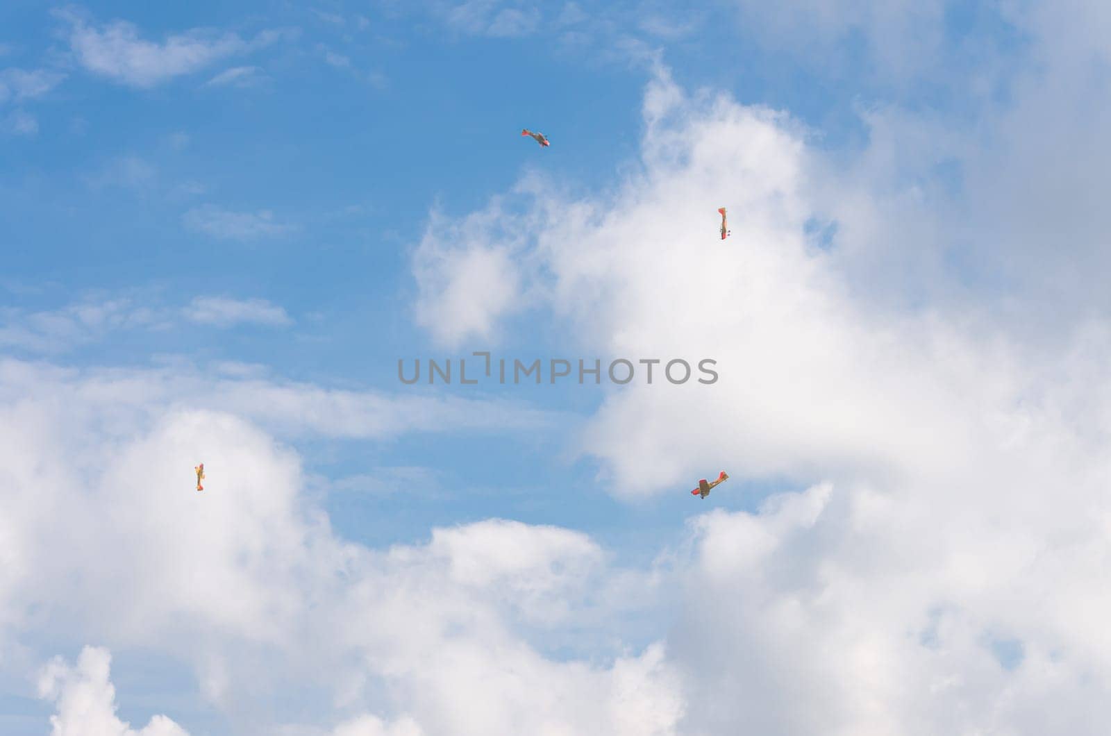 four propeller aircrafts making a looping at an air show