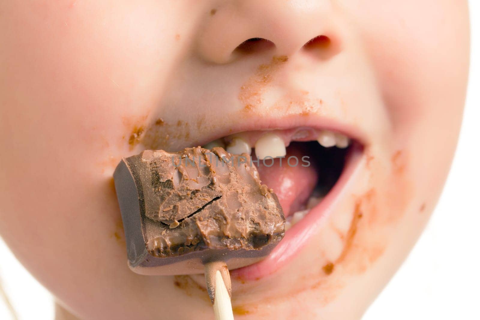 the child eating chocolate lollipop
