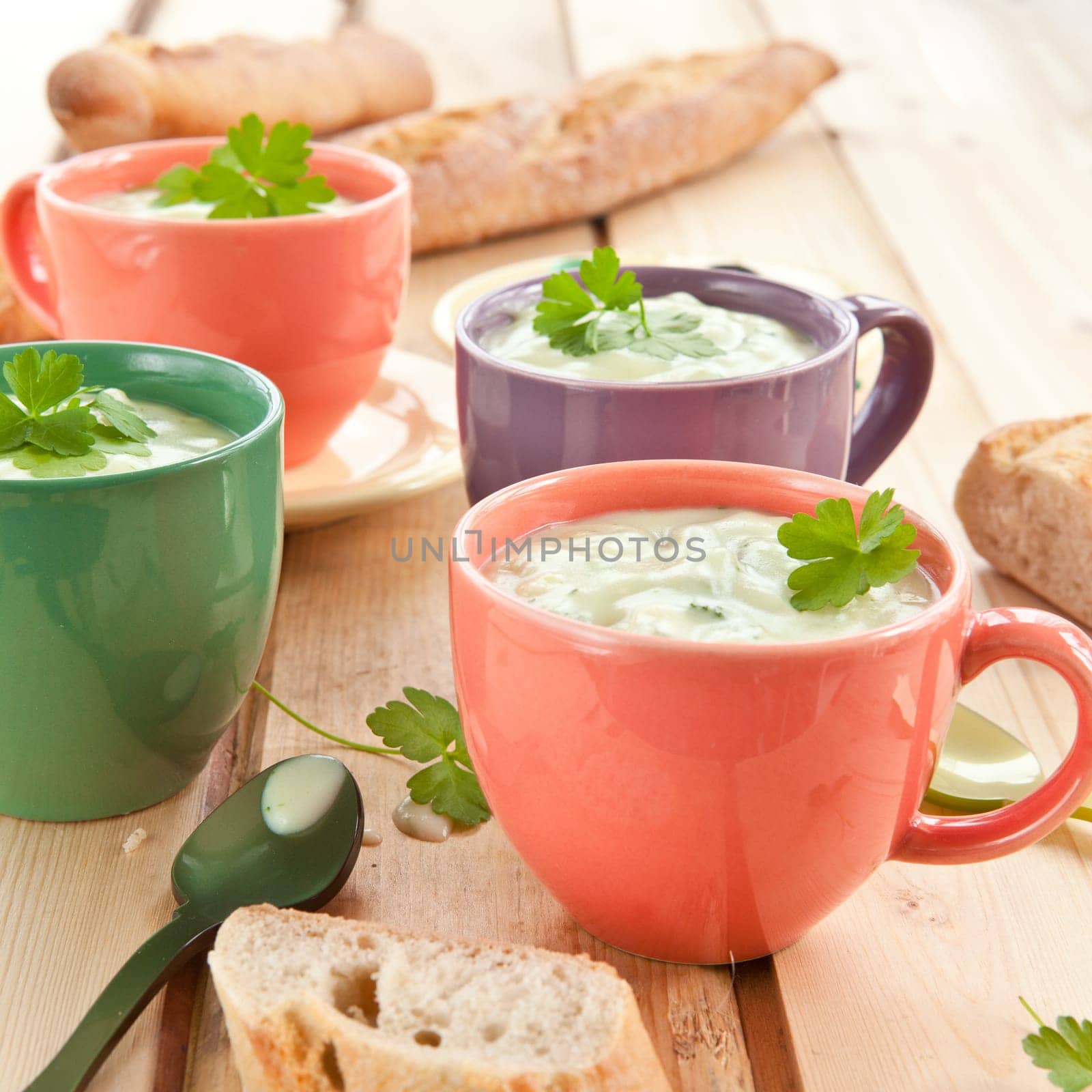 Homemade cream soup with broccoli and fresh baguette