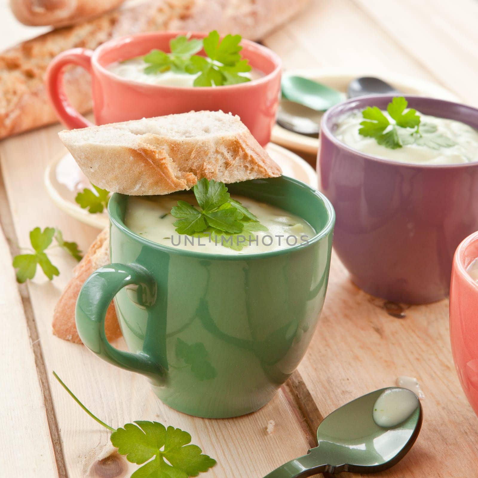Homemade cream soup with broccoli and fresh baguette