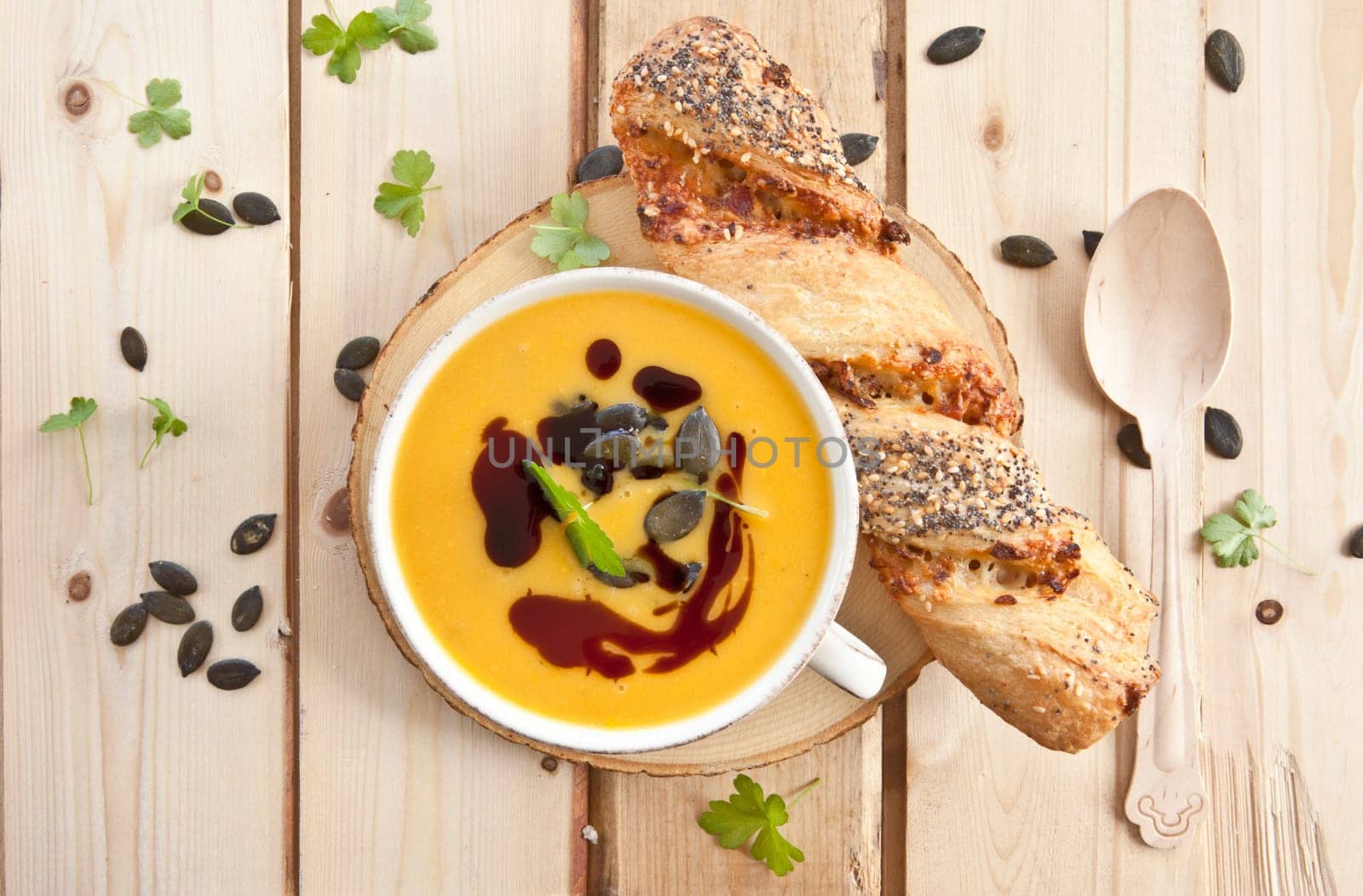 Homemade kuerbis soup in cup with stick