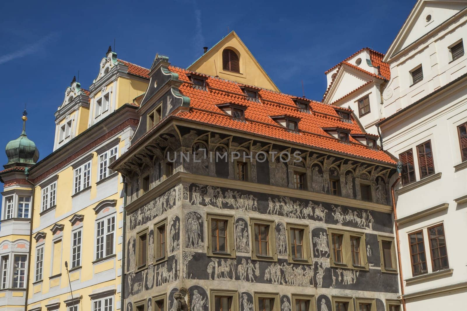 In the magical Old Town Square sits the lovely Renaissance pearl, The House at the Minute. Covered in ornate Sgraffito decorations depicting Greek mythology. (Prague, Czech Republic)