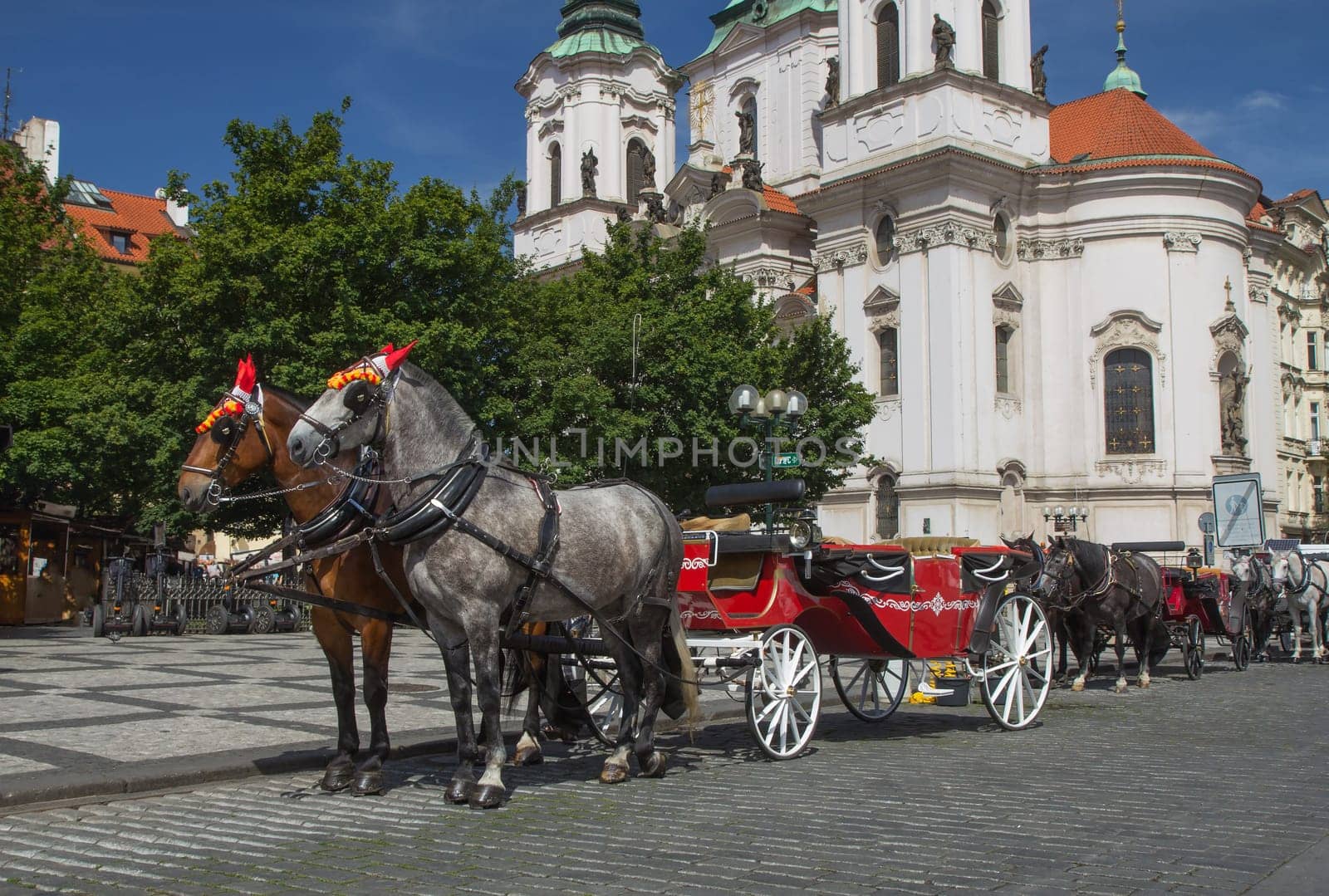 Horse-drawn carriage ready for tourists. (Old Town Square, Prague, Czech Republic.) All  potential trademarks are removed.