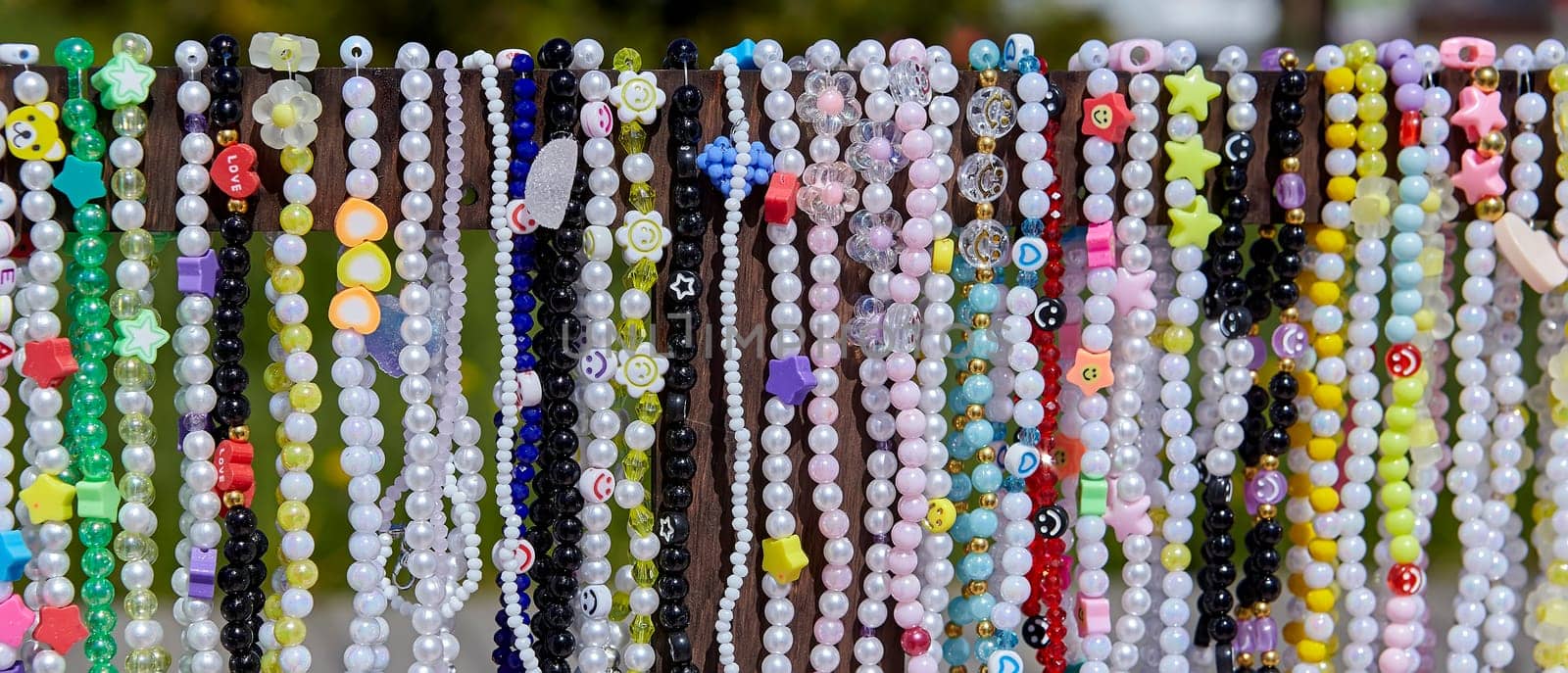 Shiny multi-colored beads made from natural semi-precious stones are beautifully arranged. by Hil