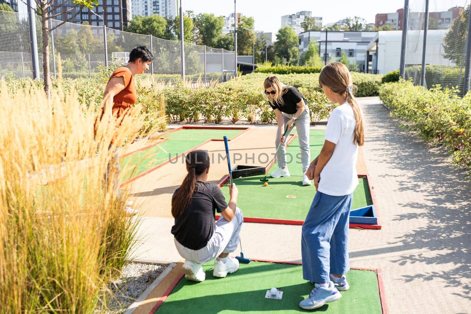 family playing mini golf on a cruise liner. Child having fun with active leisure on vacations. High quality photo