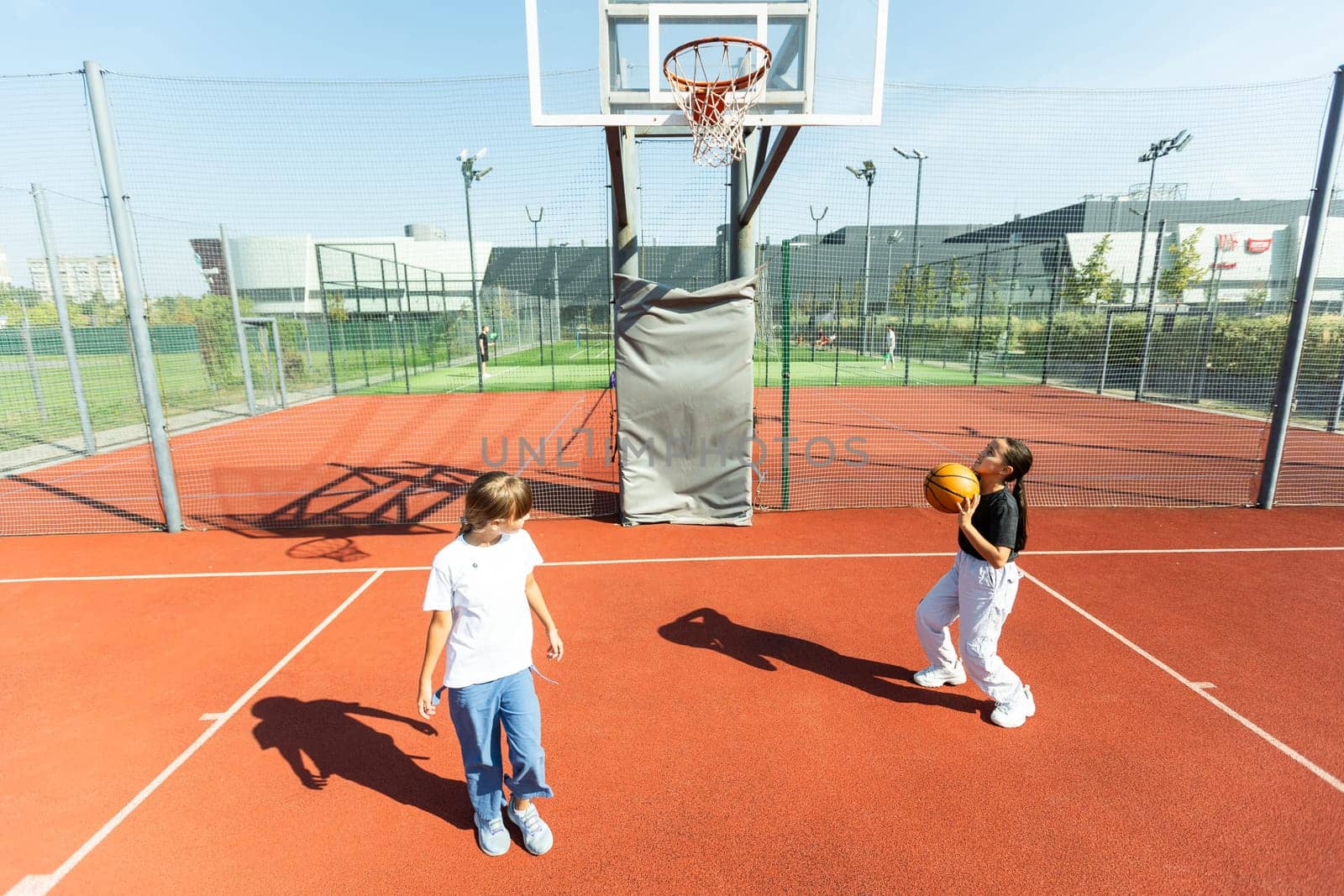 children schoolchildren playing a match about basketball against the background. High quality photo