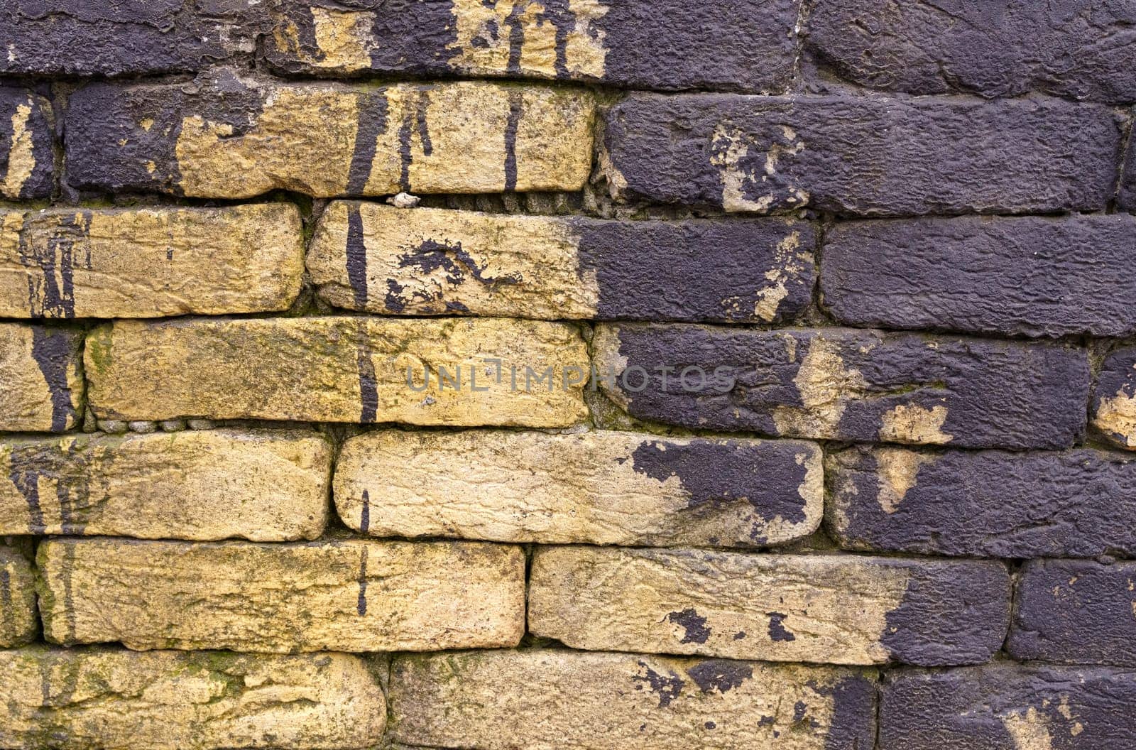 Texture of a brick wall with black paint totec elements. Stone texture.