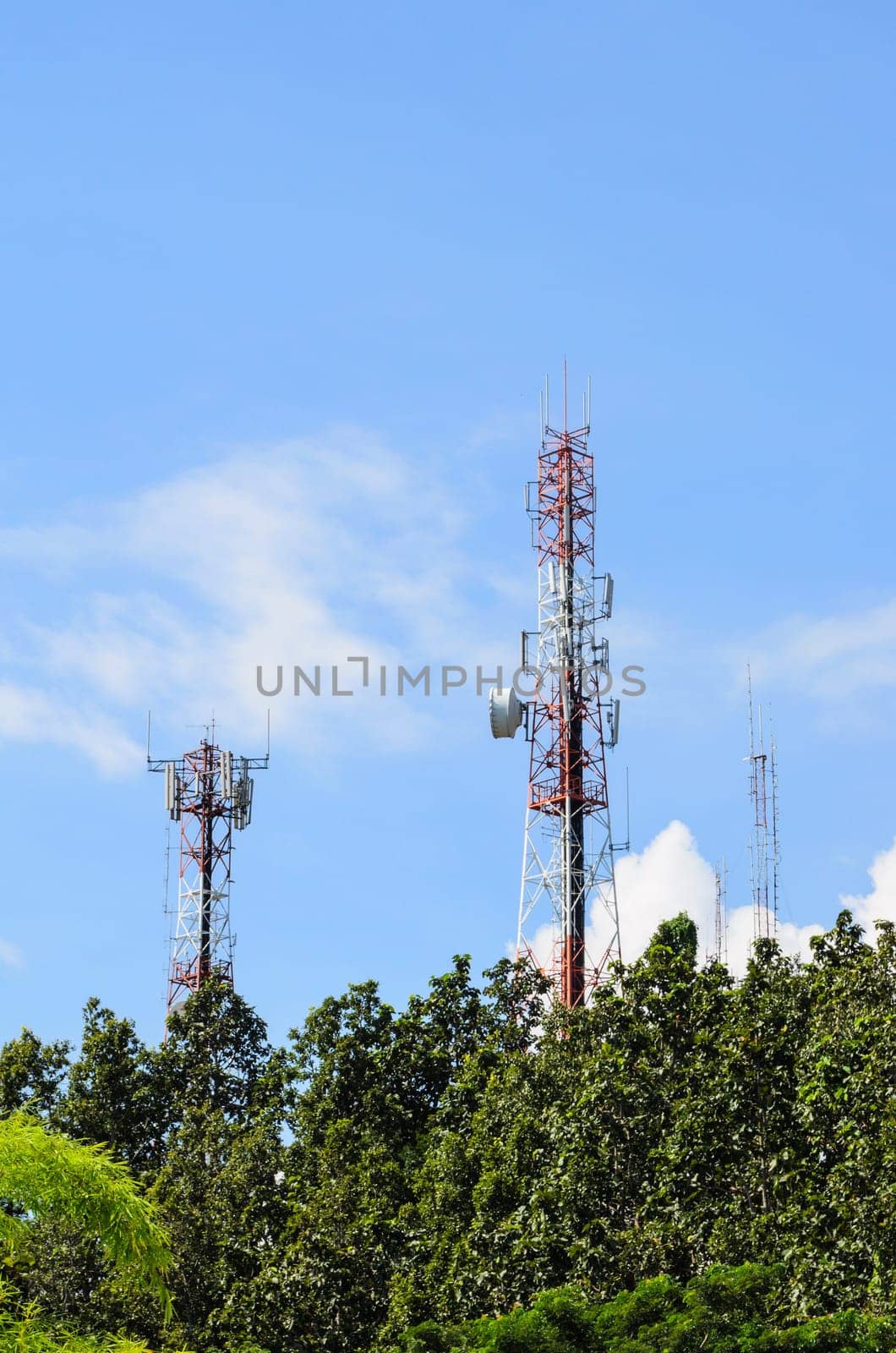 Multiplicity communications tower on blue sky background