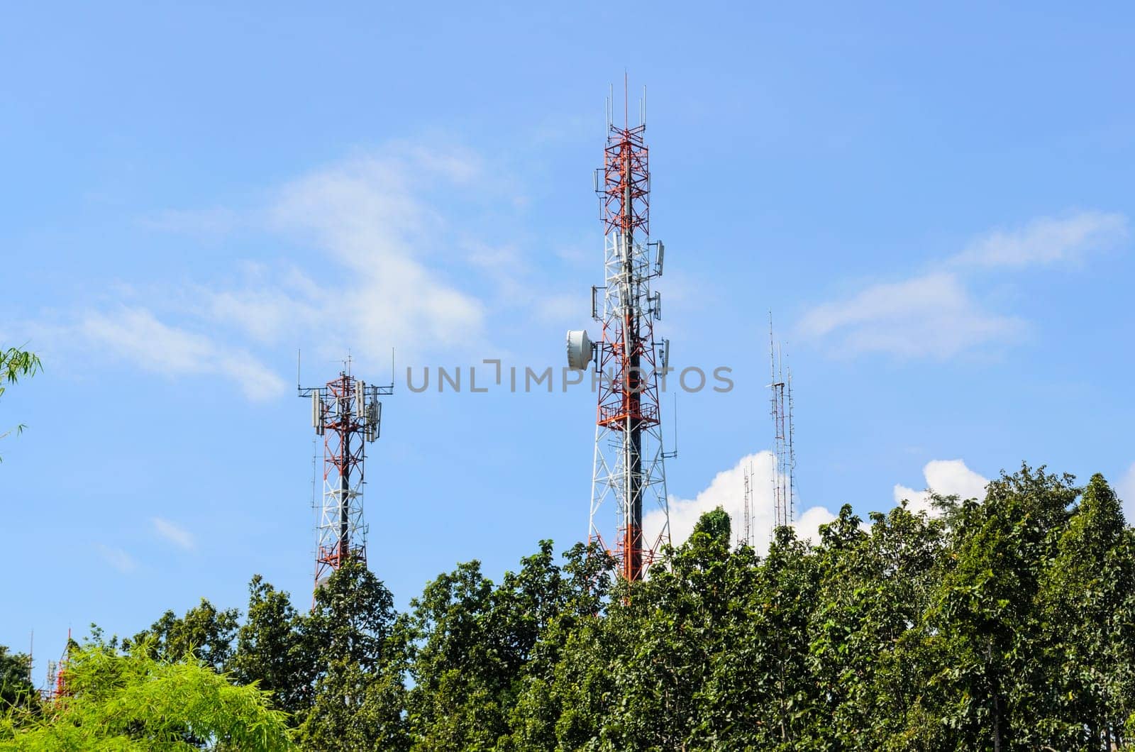 Multiplicity communications tower on blue sky background
