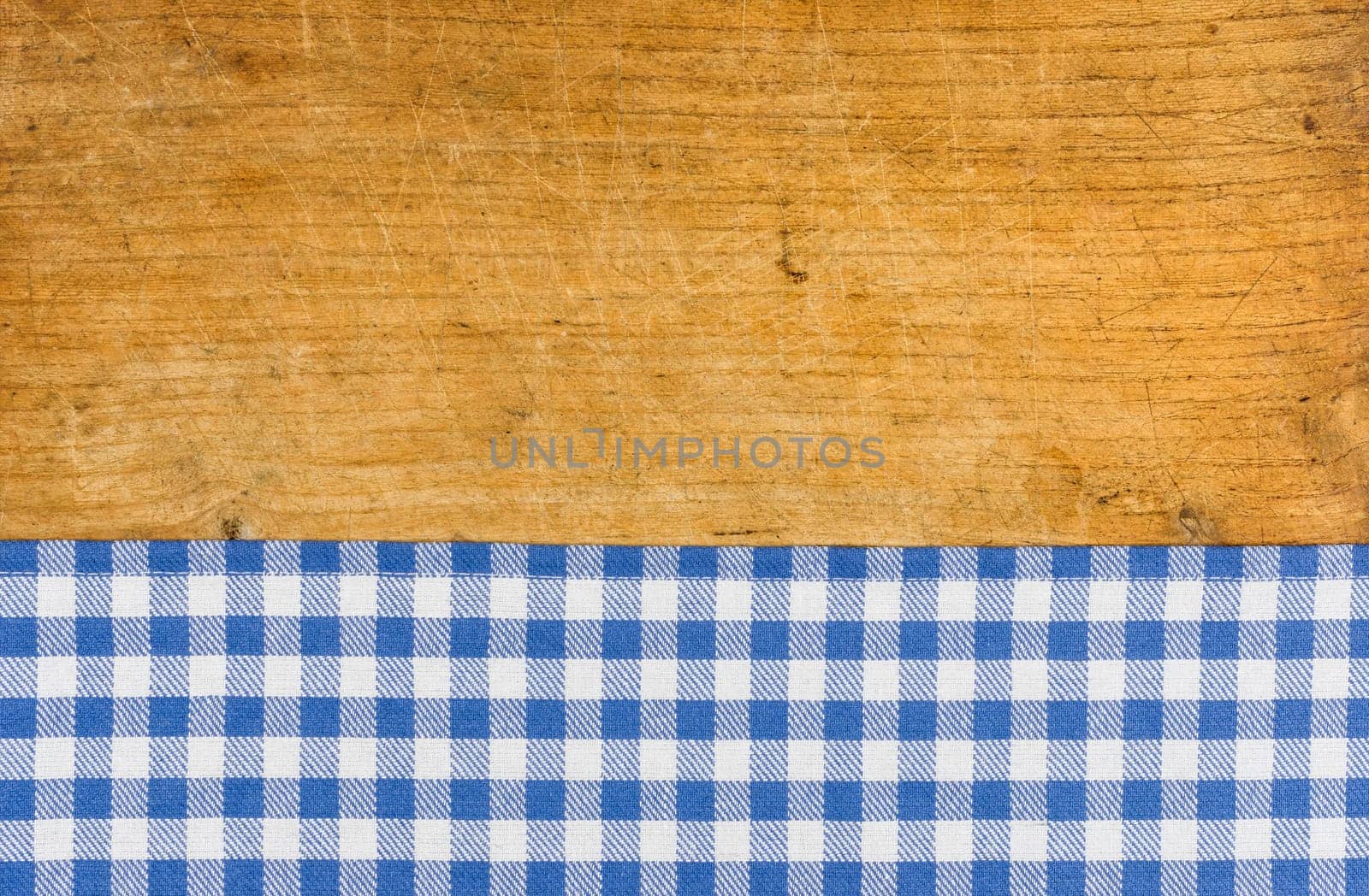 Rustic wooden background with a blue checkered tablecloth