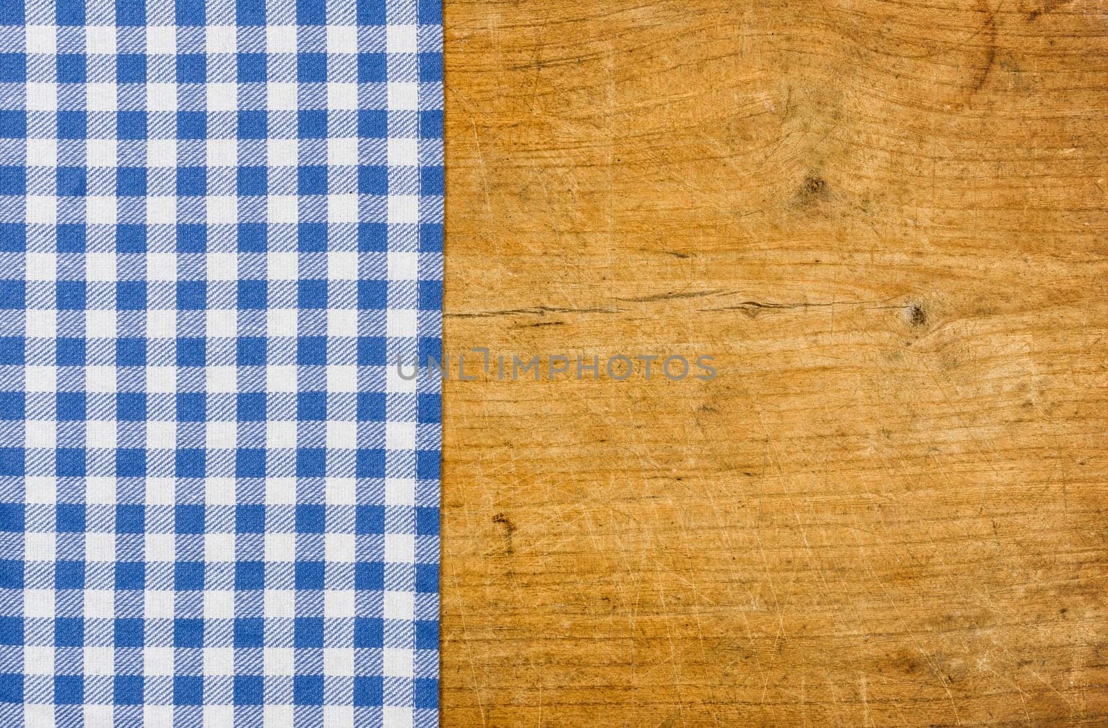 Rustic wooden background with a blue checkered tablecloth