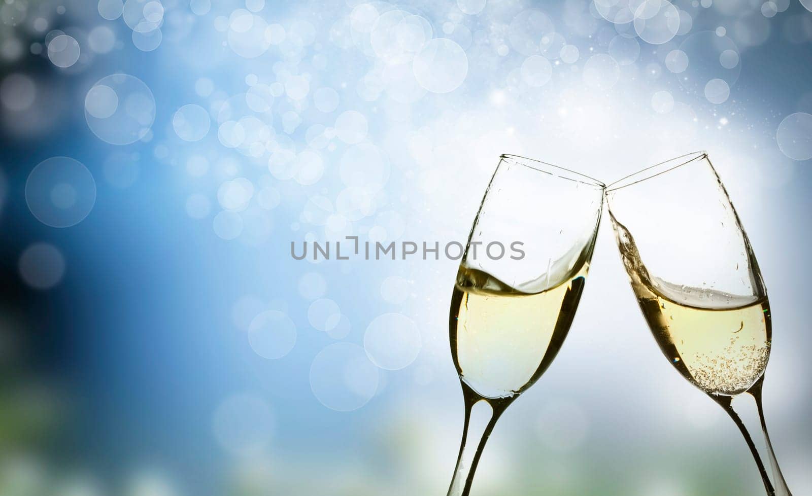 Champangne glasses on sparkling background