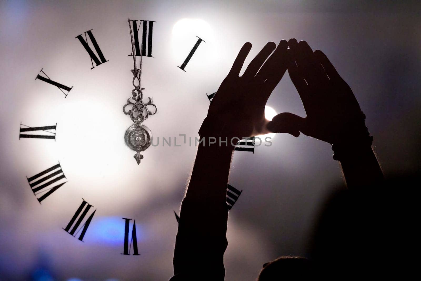 Clock close to midnight, fireworks and crowd waiting for New year