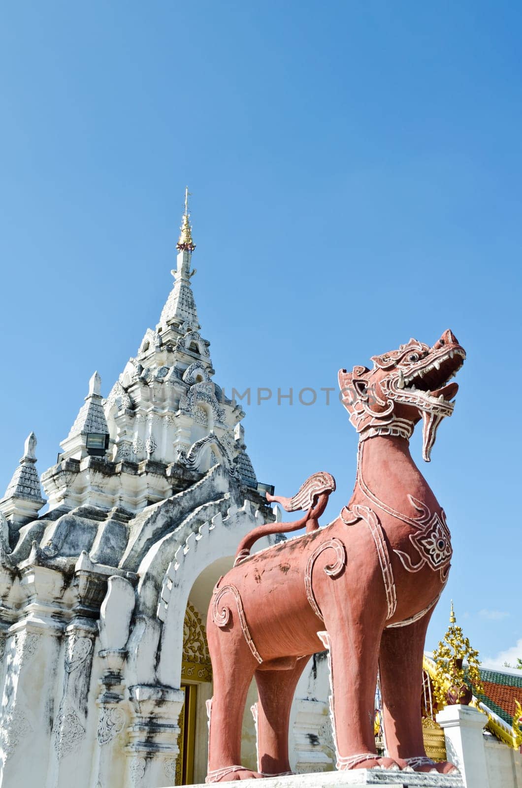 Red Lion statue at front Wat Phra That Hariphunchai temple in Lamphun Province of Thailand