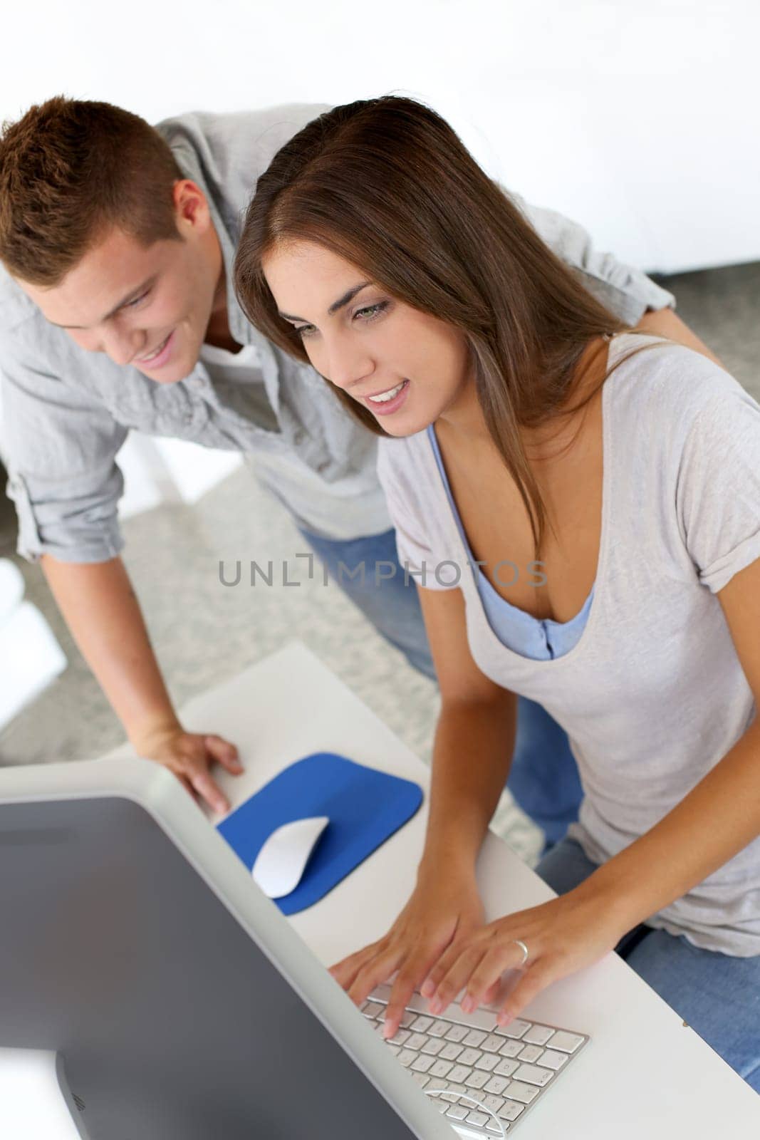 Young people working in office on desktop computer