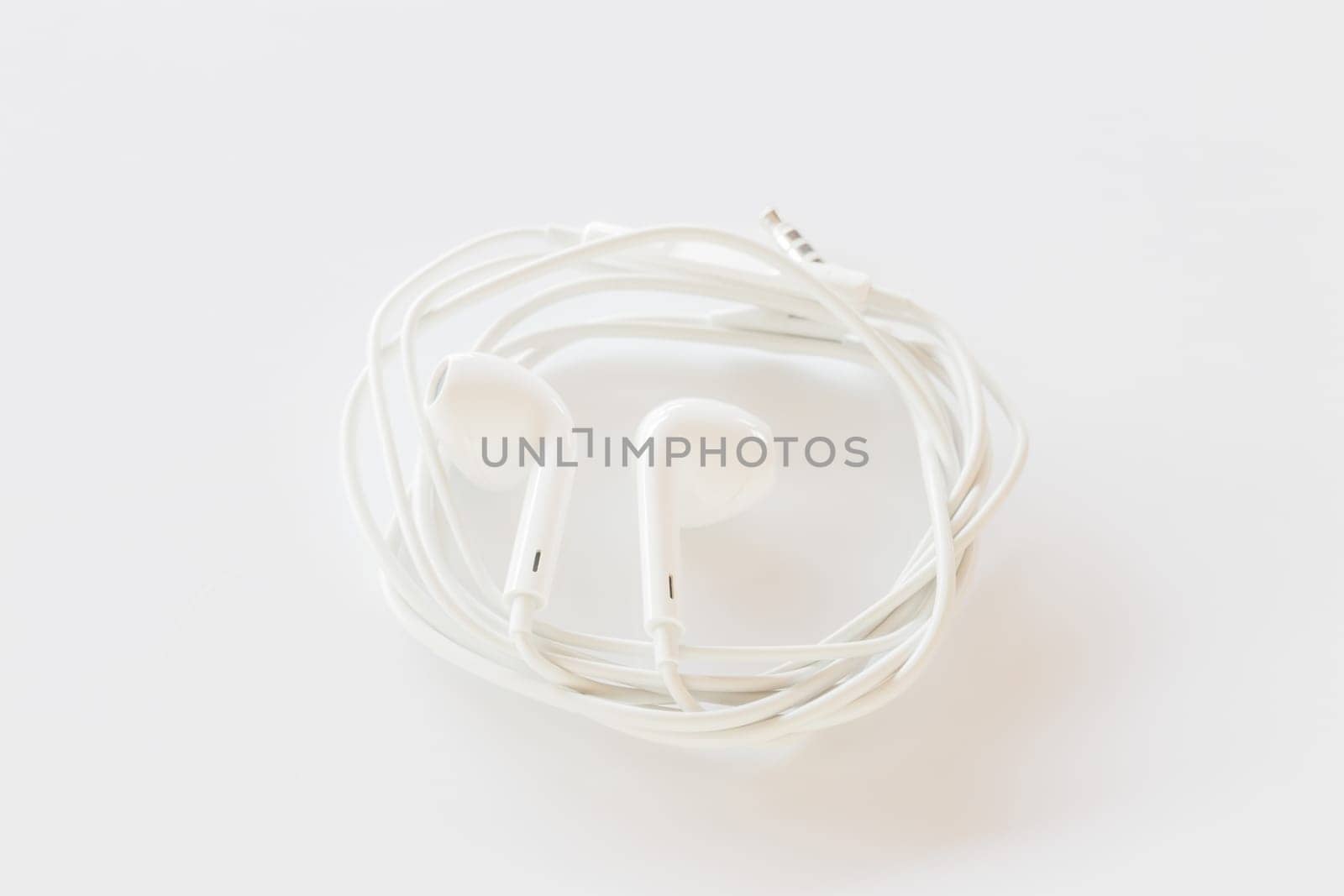 Smartphone ear buds isolated on white background, stock photo