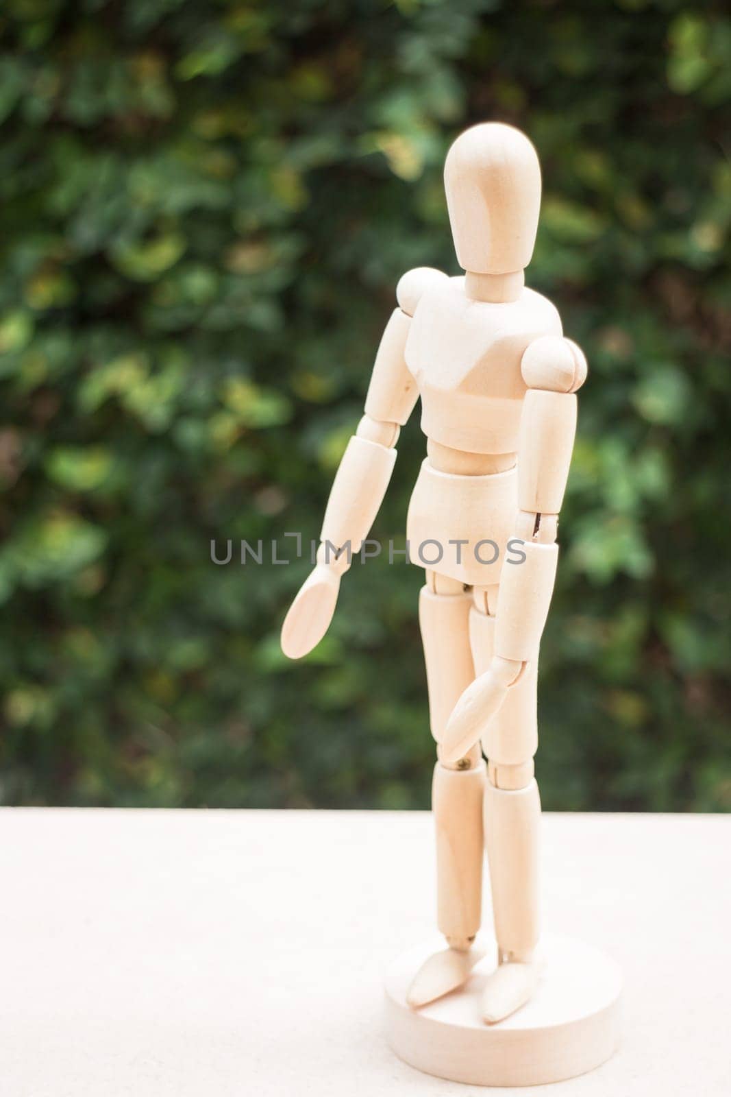 Wooden artist manikin pose on the table, stock photo